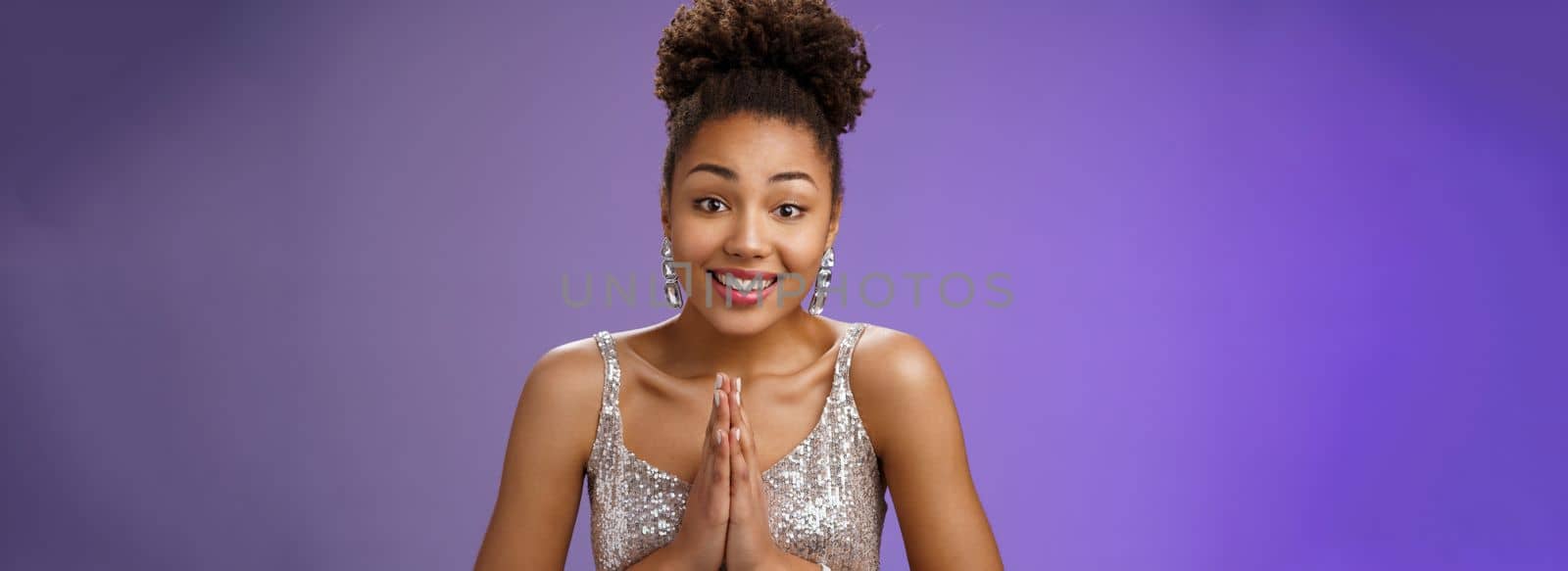 Close-up hopeful charming flirty african-american woman in silver stylish dress press palms together pray begging gesture asking help favour smiling broadly thankful, smiling grateful gladly.