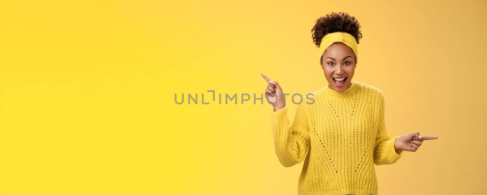 Energized active charismatic african-american woman afro hairstyle in sweater headband screaming fascinated enthusiastic pointing left right impressed variaty awesome choices, picking products by Benzoix