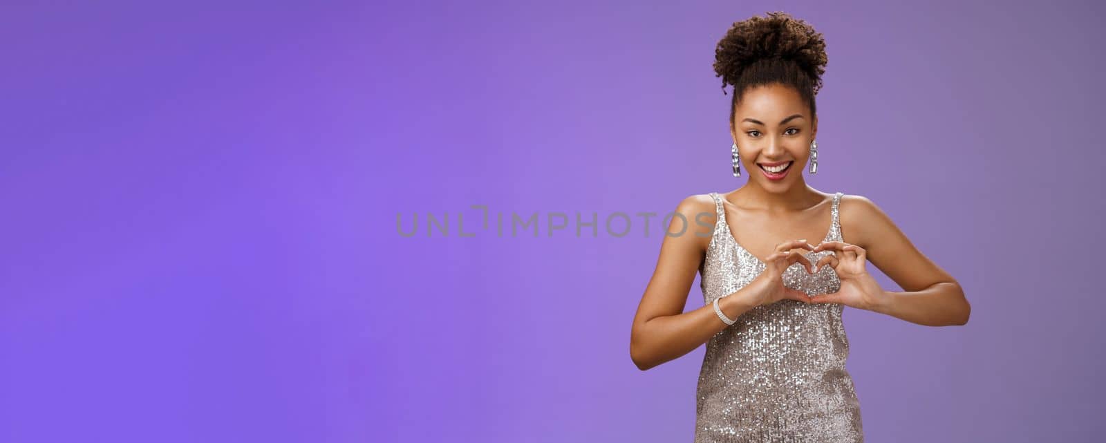 Girl totally loved adores look grateful deisgners. peek elegant dress b-day party show heart gesture smiling happily expressing love heartwarming passionate feelings standing gladly blue background.