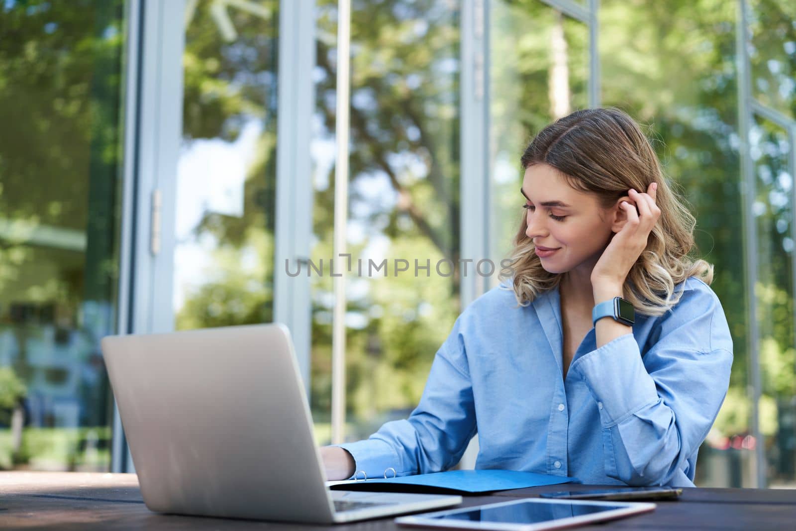 Portrait of corporate woman with laptop, working on project, using computer outdoors. Young student doing homework outside on fresh air by Benzoix