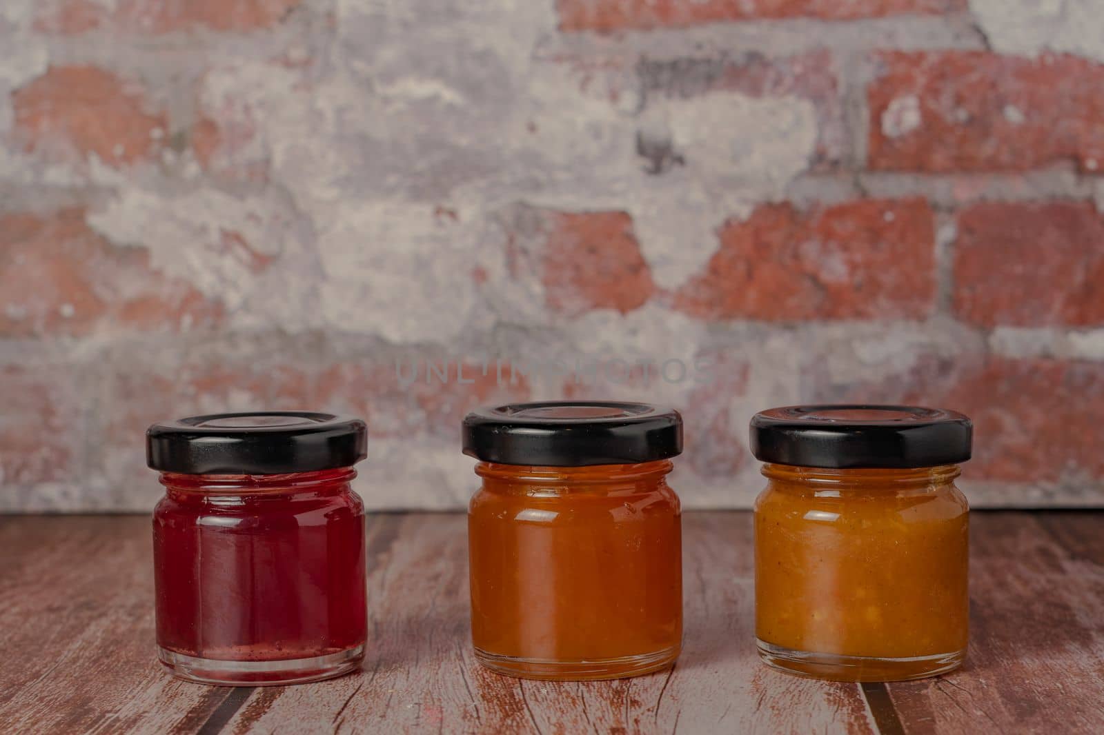 three jars of marmalade of different flavors by joseantona