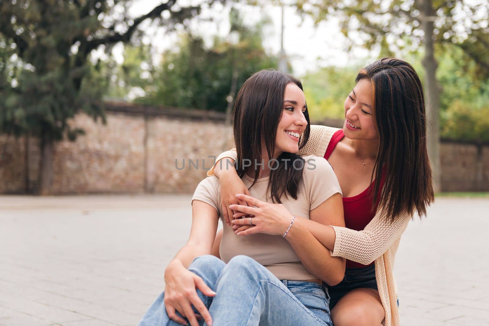 portrait of a young couple of friends looking at each other with affection, concept of love and teenager lifestyle, copy space for text