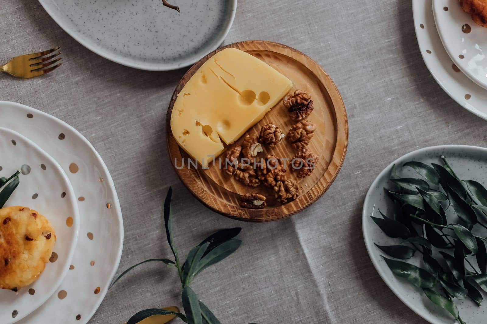 Hard nut cheese with nuts on a plate with snacks. Rustic style. Free copy space