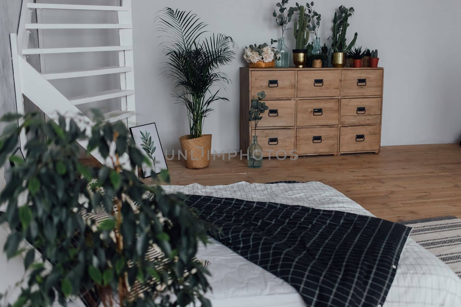 Stylish chest of drawers in a bright and white apartment under natural lighting.