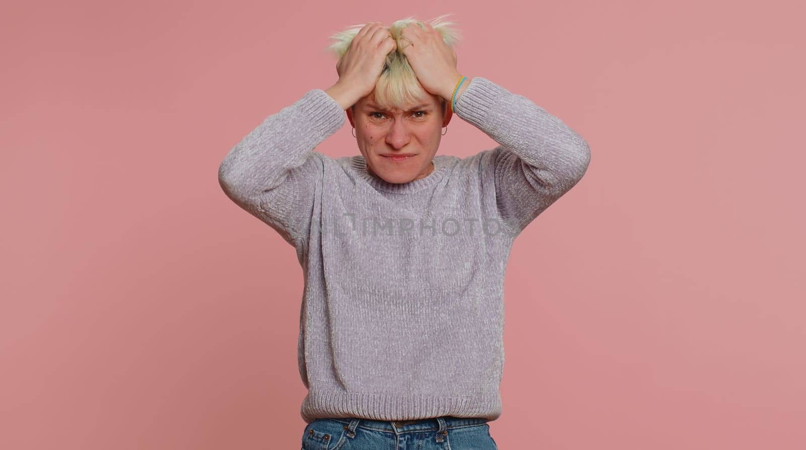 Young pretty woman feeling hopelessness loneliness, nervous breakdown, loses becoming surprised by lottery results, bad fortune, loss, unlucky news. Girl on pink background. Lgbt gay lesbian people