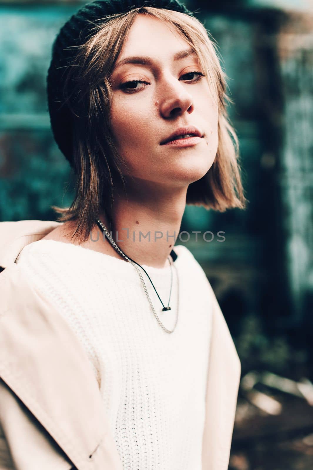 Close-up portrait Beautiful elegant woman wearing beige coat and black hat. Trendy casual outfit. Soft selective focus. grain.