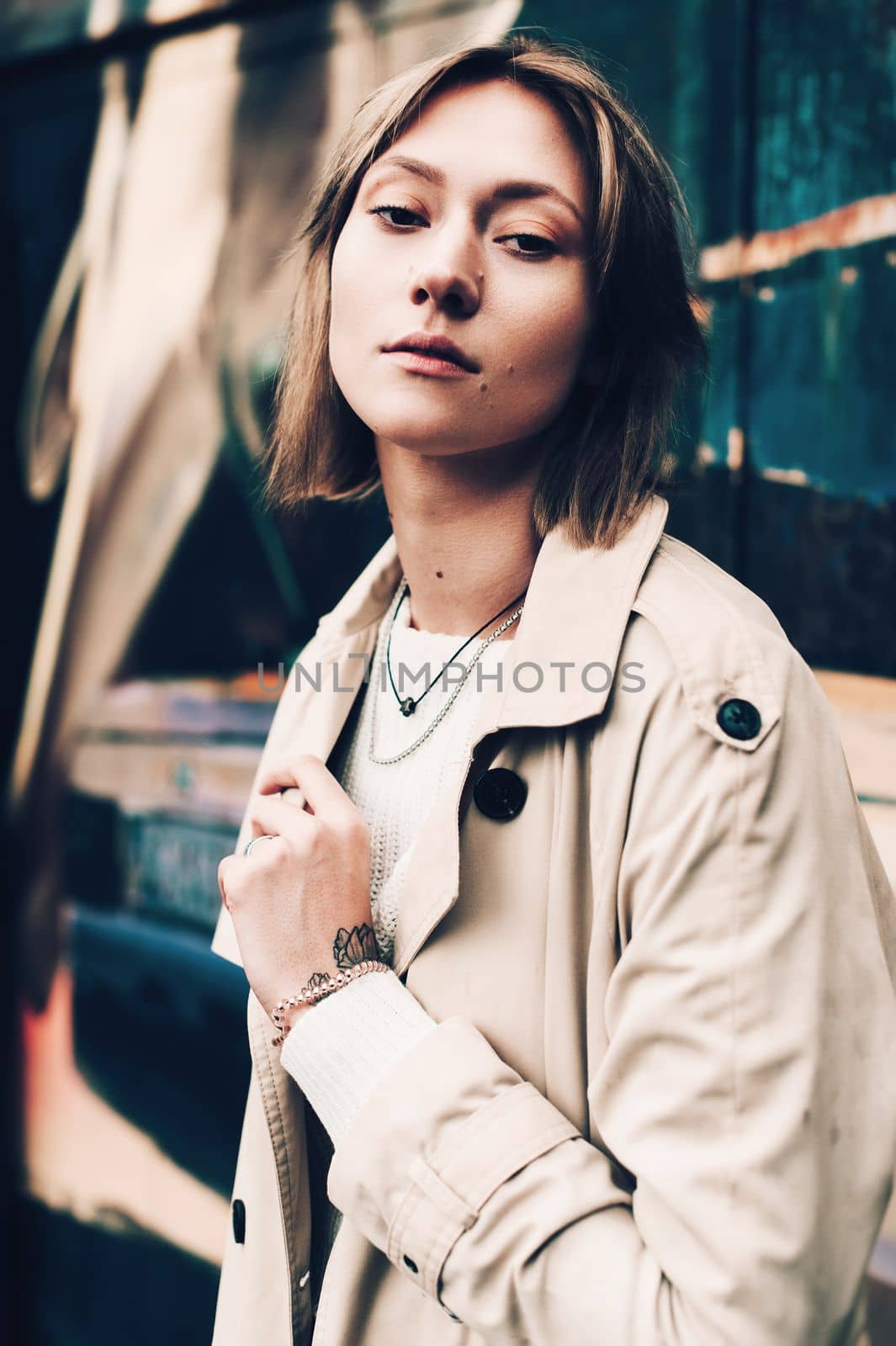 Close-up portrait Beautiful elegant woman wearing beige coat and black hat. Trendy casual outfit. Soft selective focus. grain.