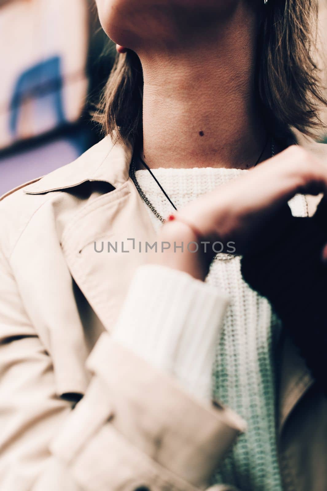 Close-up portrait Beautiful elegant woman wearing beige coat and black hat. Trendy casual outfit. Soft selective focus. grain.