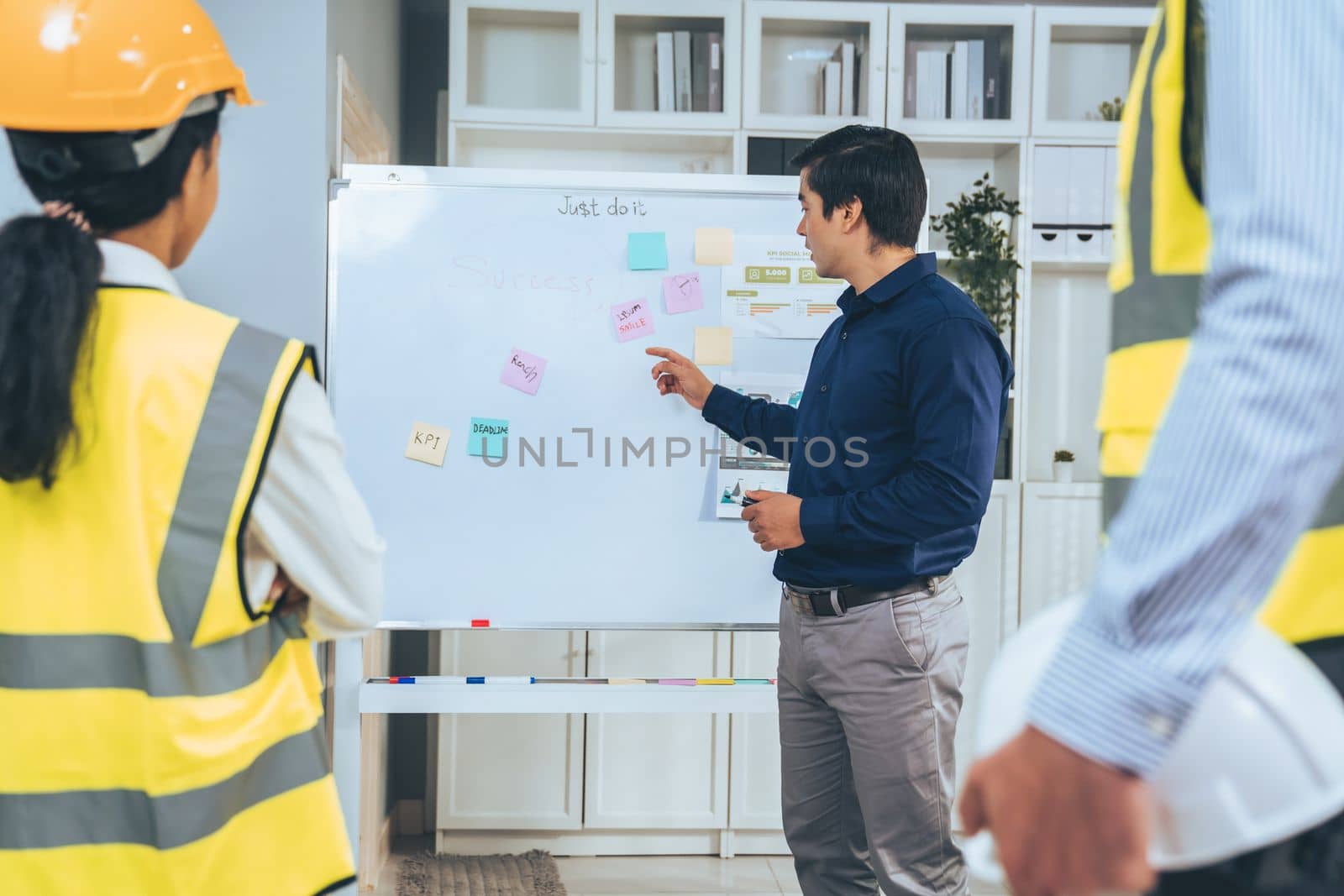 A team of investor and competent engineers brainstorming on the whiteboard to find new ideas and making plans. The idea of a team gather ideas together.