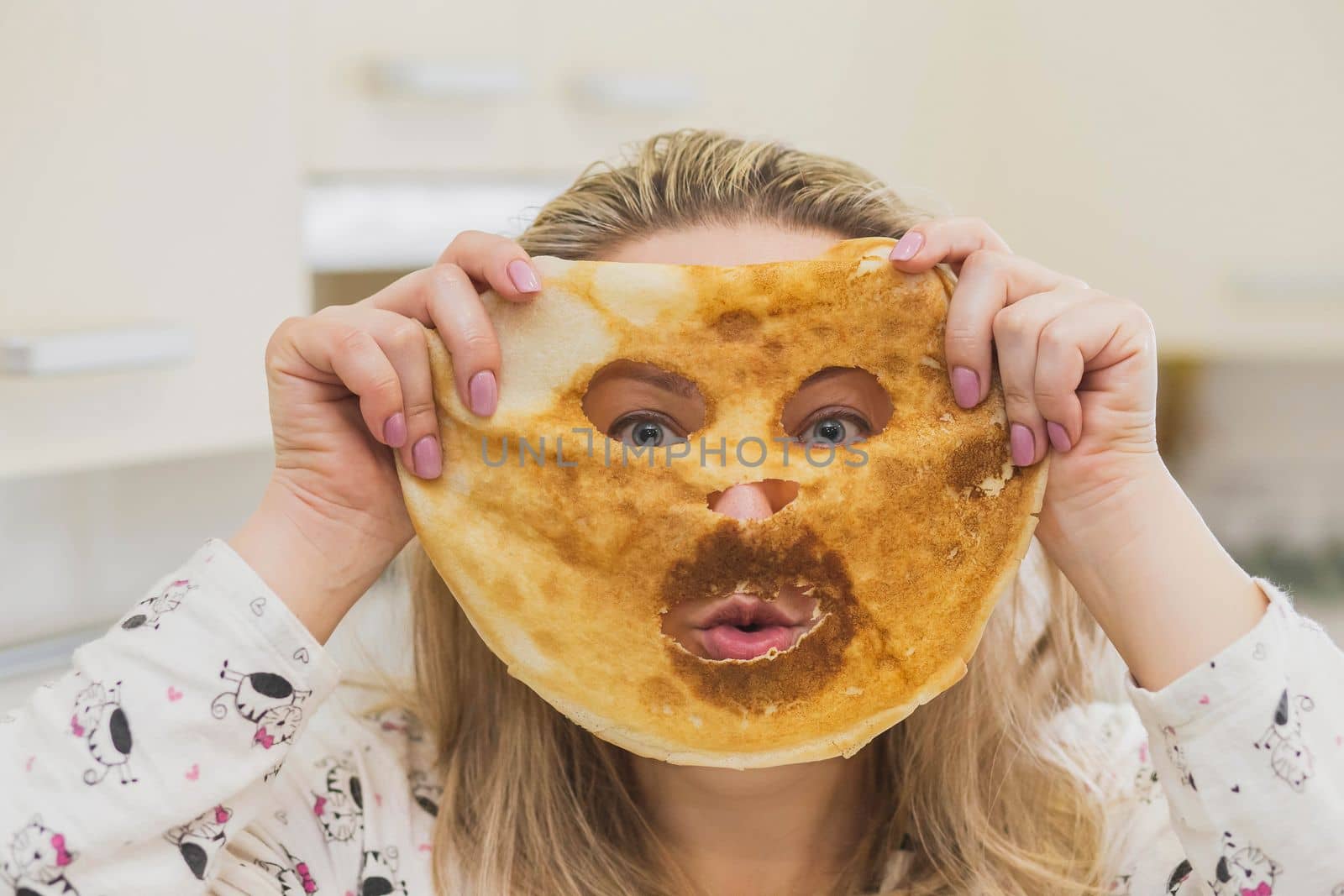 Woman in pajamas made a pancake mask.