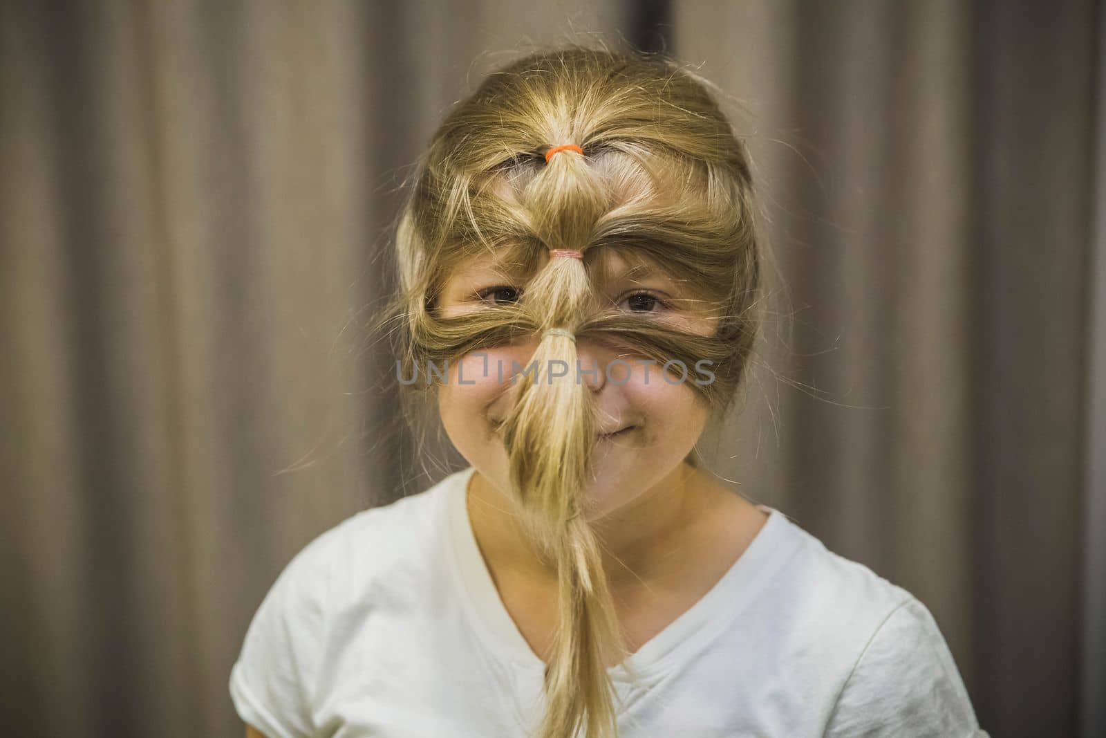 girl for fun made from hair a mask on her face.