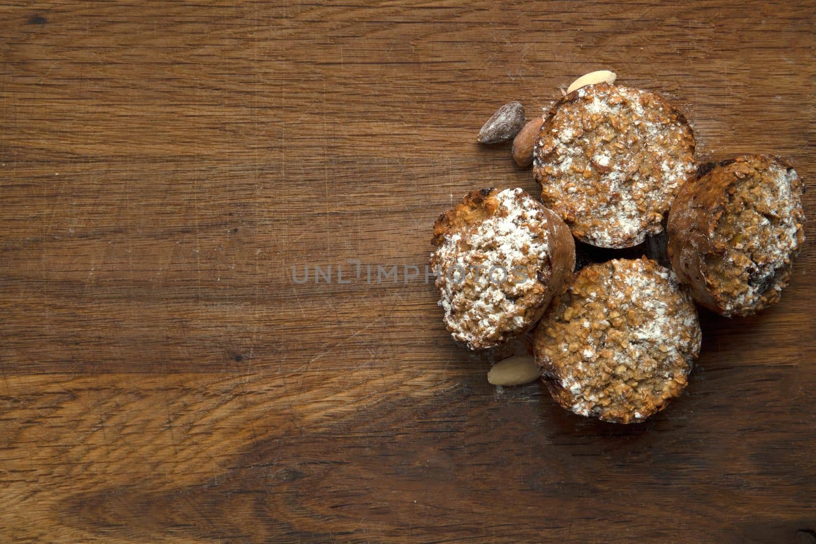 Freshly baked banana muffins top view on wooden background with copy space, healthy vegan cupcakes, diet vegetarian concept top view