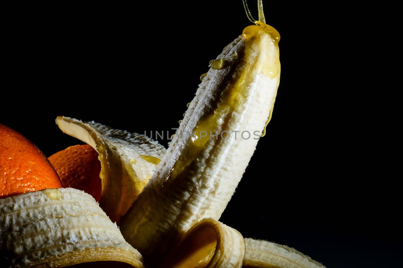 Close-up eating peeled banana by Andelov13