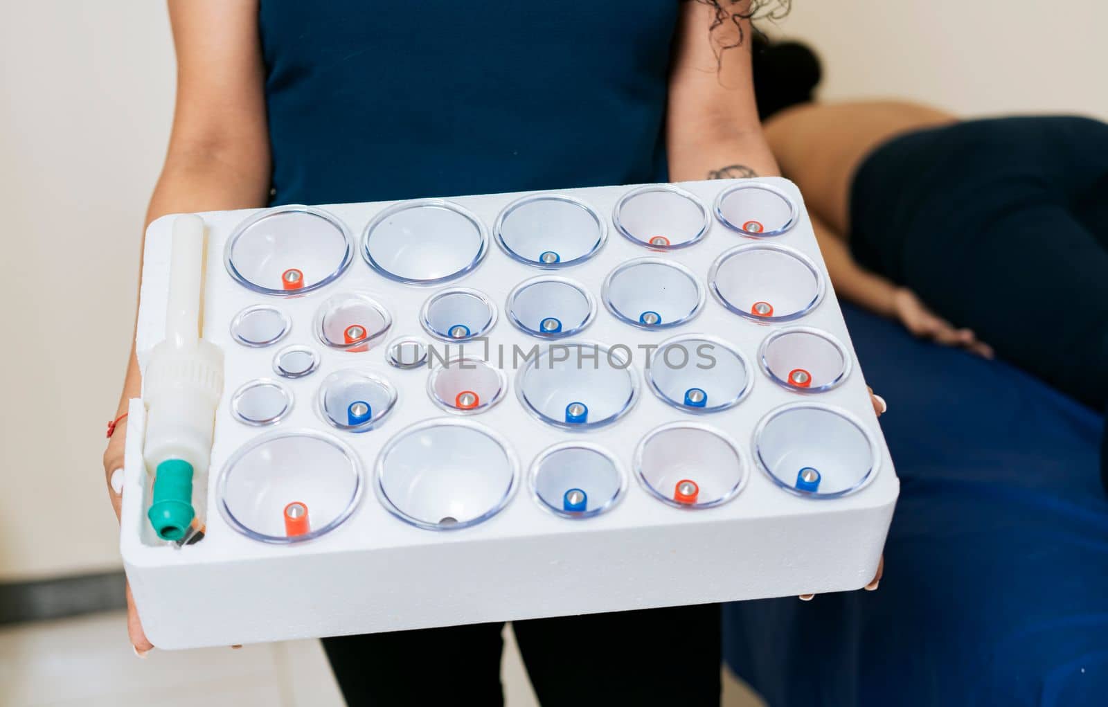 Physiotherapist hands holding cupping cups, Hands holding cupping box for physiotherapy, Cupping kit for physiotherapy