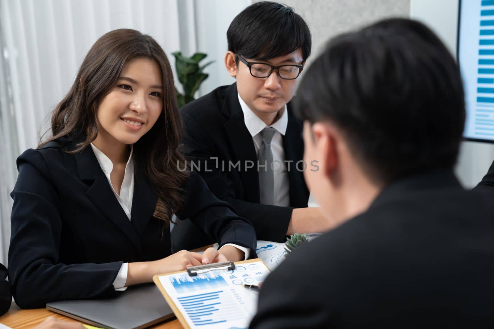 Business team of financial data analysis meeting with business intelligence, report paper and dashboard on laptop for marketing strategy. Business people working together to promote harmony in office.