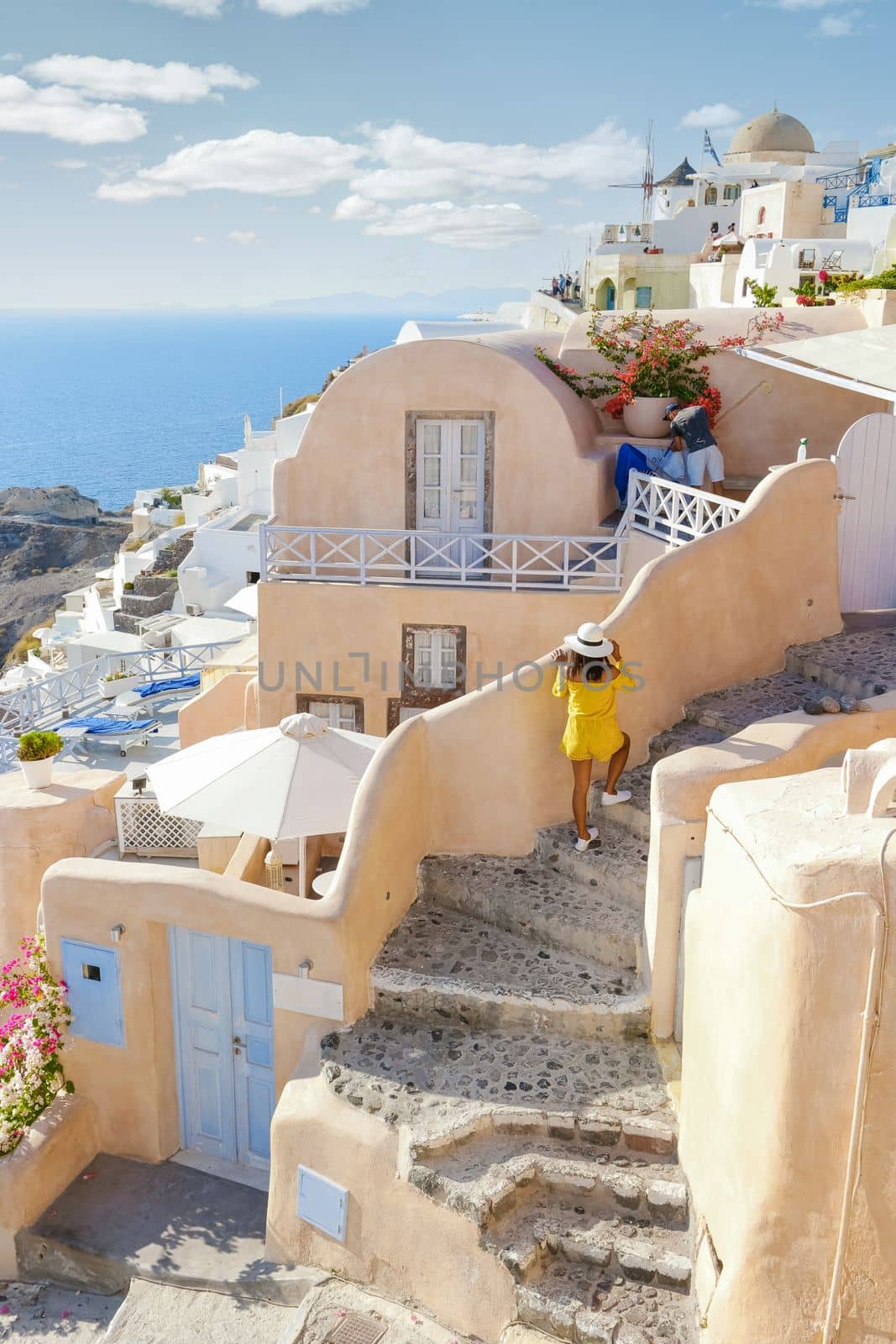 streets of the village of Oia Santorini Greece on a sunny day during summer with whitewashed homes and churches, Greek Island Aegean Cyclades