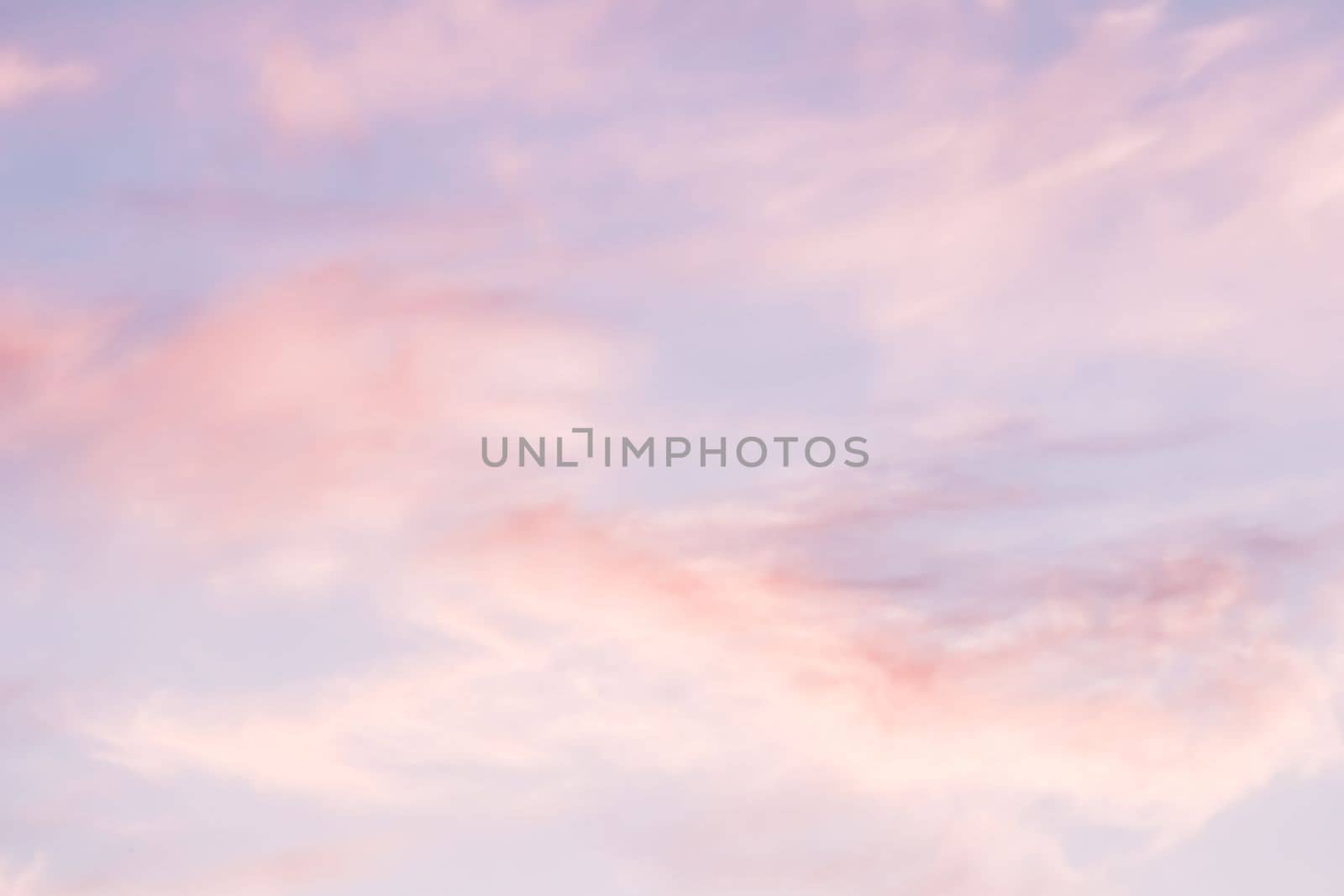 Blue sky background with white and pink clouds at sunset. High quality photo