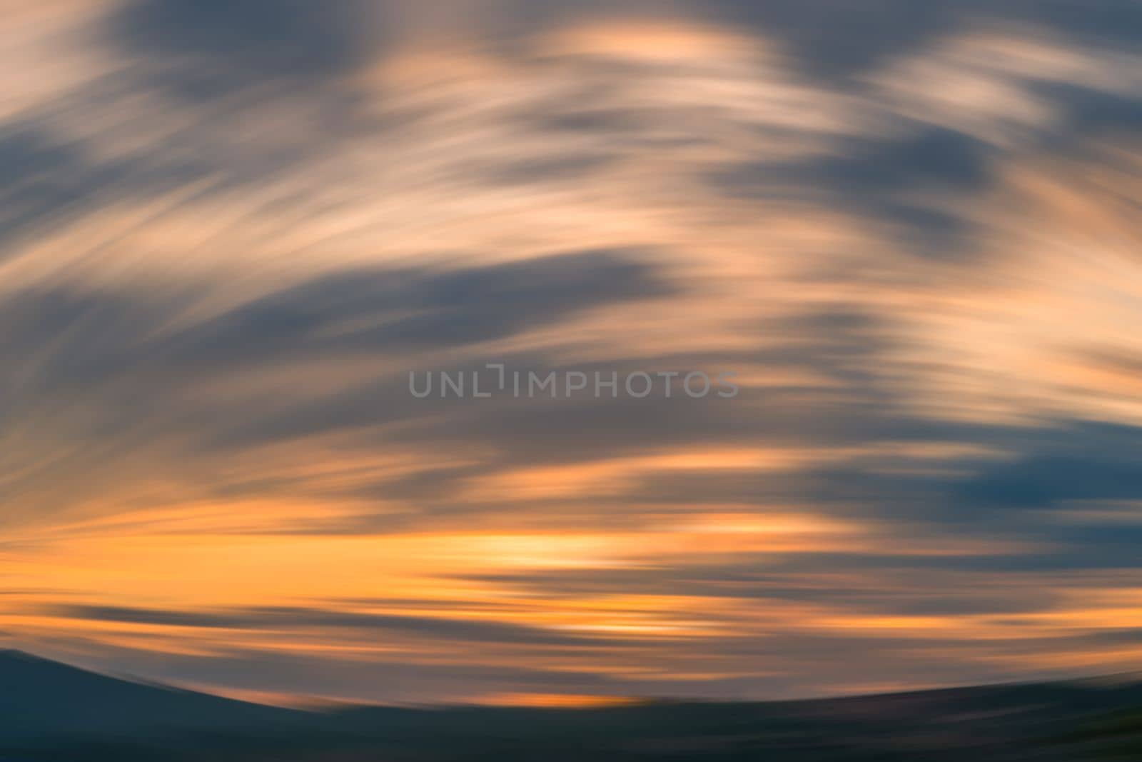 Sunset mountain round motion blur background. orange lines shadow cloudscape sky.