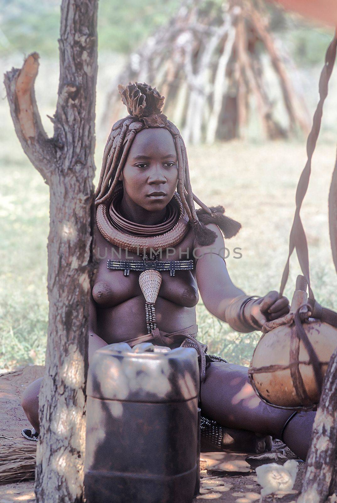 May 15, 2005. portrait of unidentified Himba woman with the traditional hairstyle, necklace and the typical ochre tinted skin. Epupa Falls, Kaokoland or Kunene Province, Namibia, Africa