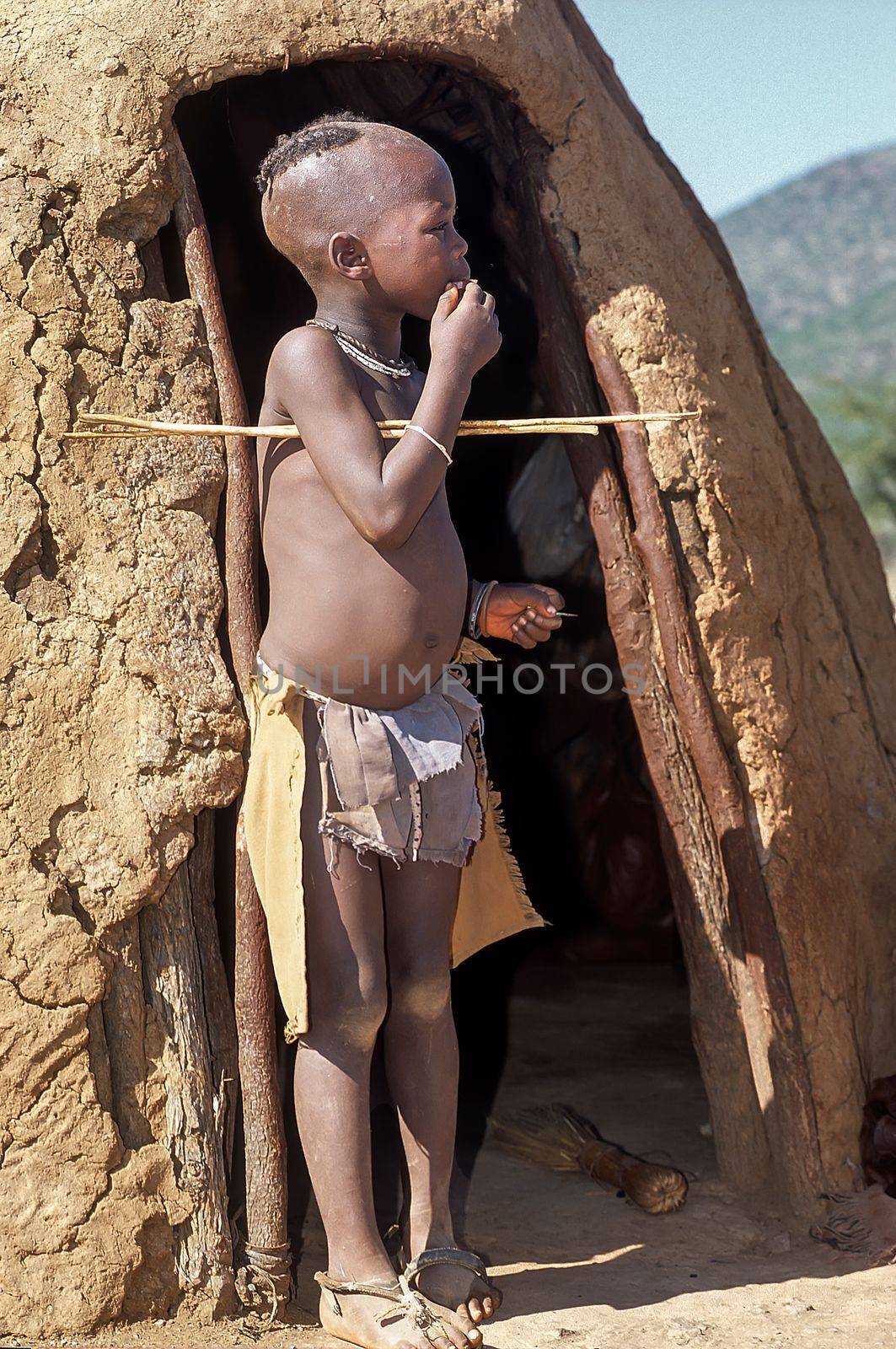 May 15, 2005. unidentified himba boy in the traditional hut, Epupa Falls, Kaokoland or Kunene Province, Namibia, Africa