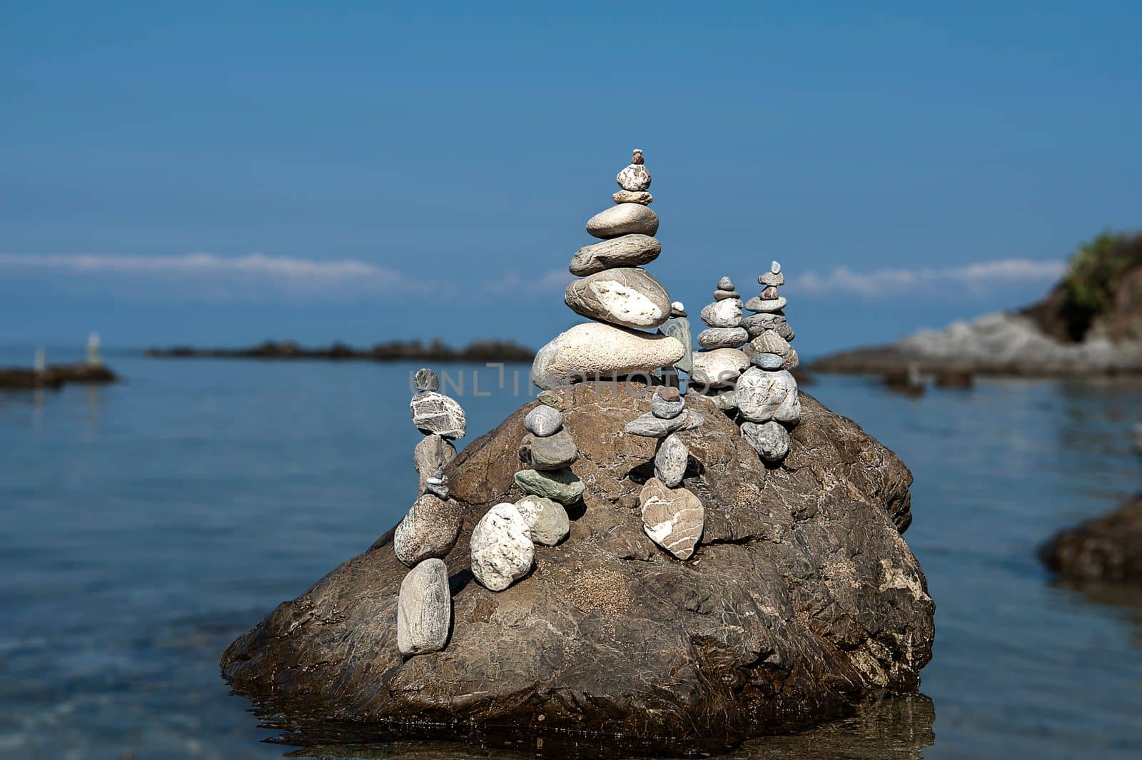 balanced stones on the rocks of the sea