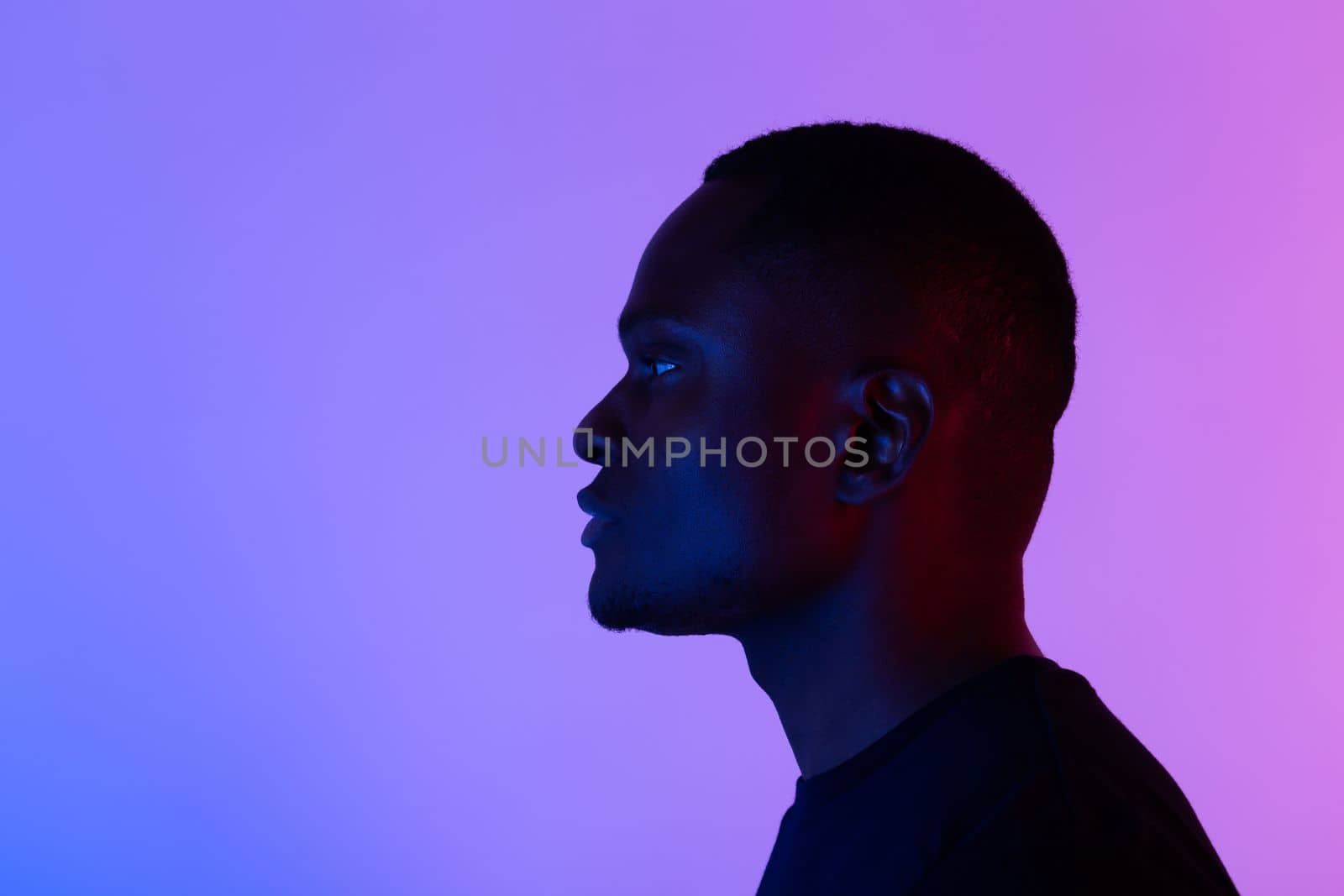 Silhouette head of sad african american man on colourful neon isolated background with copy space by Satura86