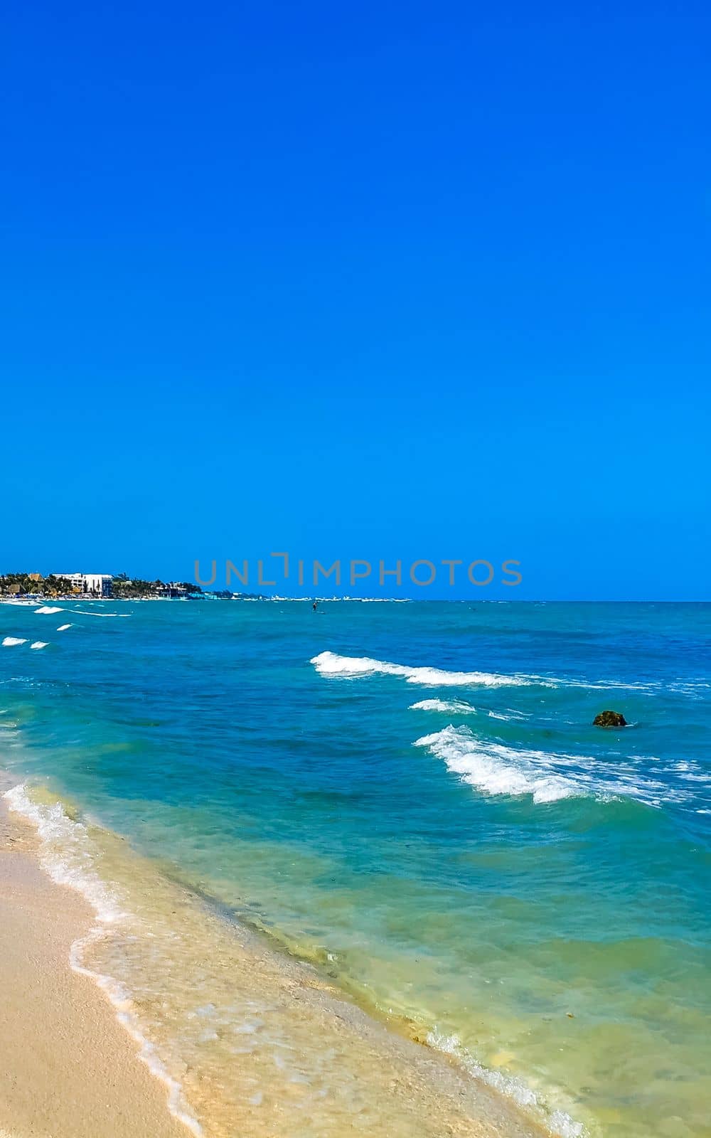 Tropical caribbean beach landscape panorama with clear turquoise blue water in Playa del Carmen Mexico.