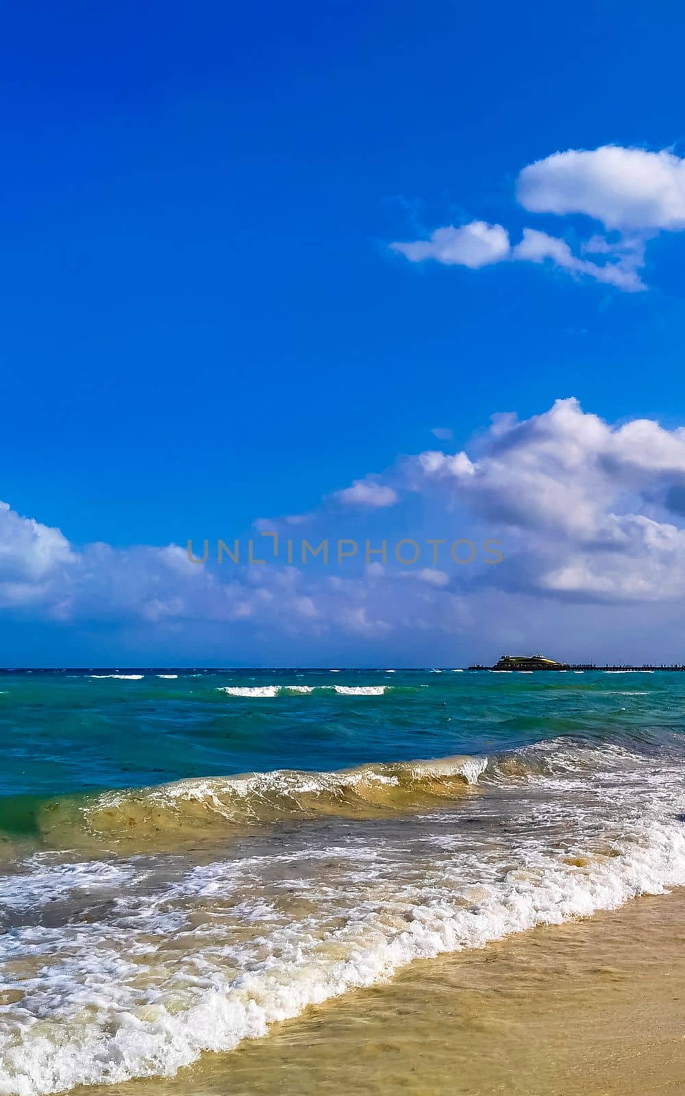 Tropical caribbean beach landscape panorama with clear turquoise blue water in Playa del Carmen Mexico.