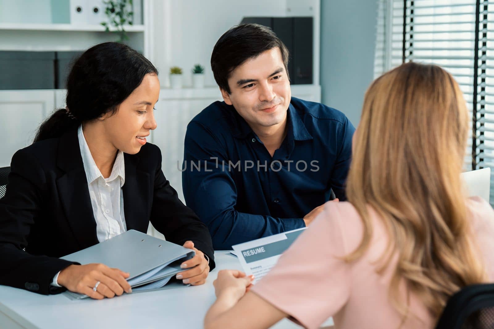 A young female asian candidate tries to impress her interviewer by being competent. International company, multicultural environment in workplace.