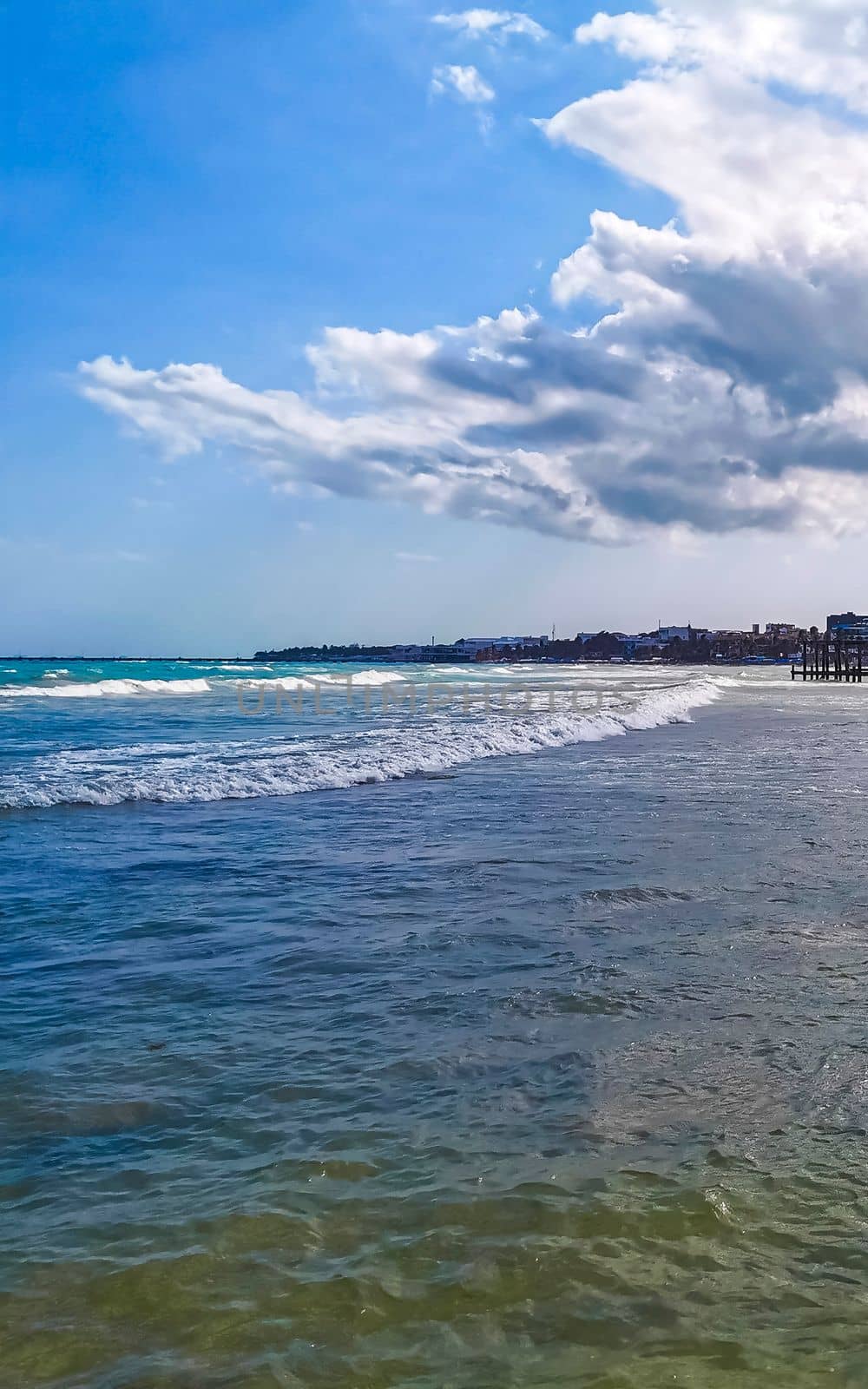 Tropical caribbean beach landscape panorama with clear turquoise blue water in Playa del Carmen Mexico.