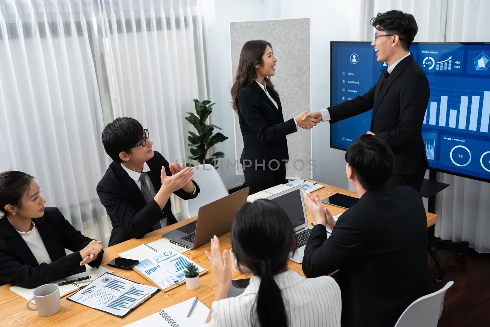 Businesspeople shake hand after successful agreement or meeting. Office worker colleague handshake with business team leader manager for strong teamwork in office to promote harmony and unity concept.