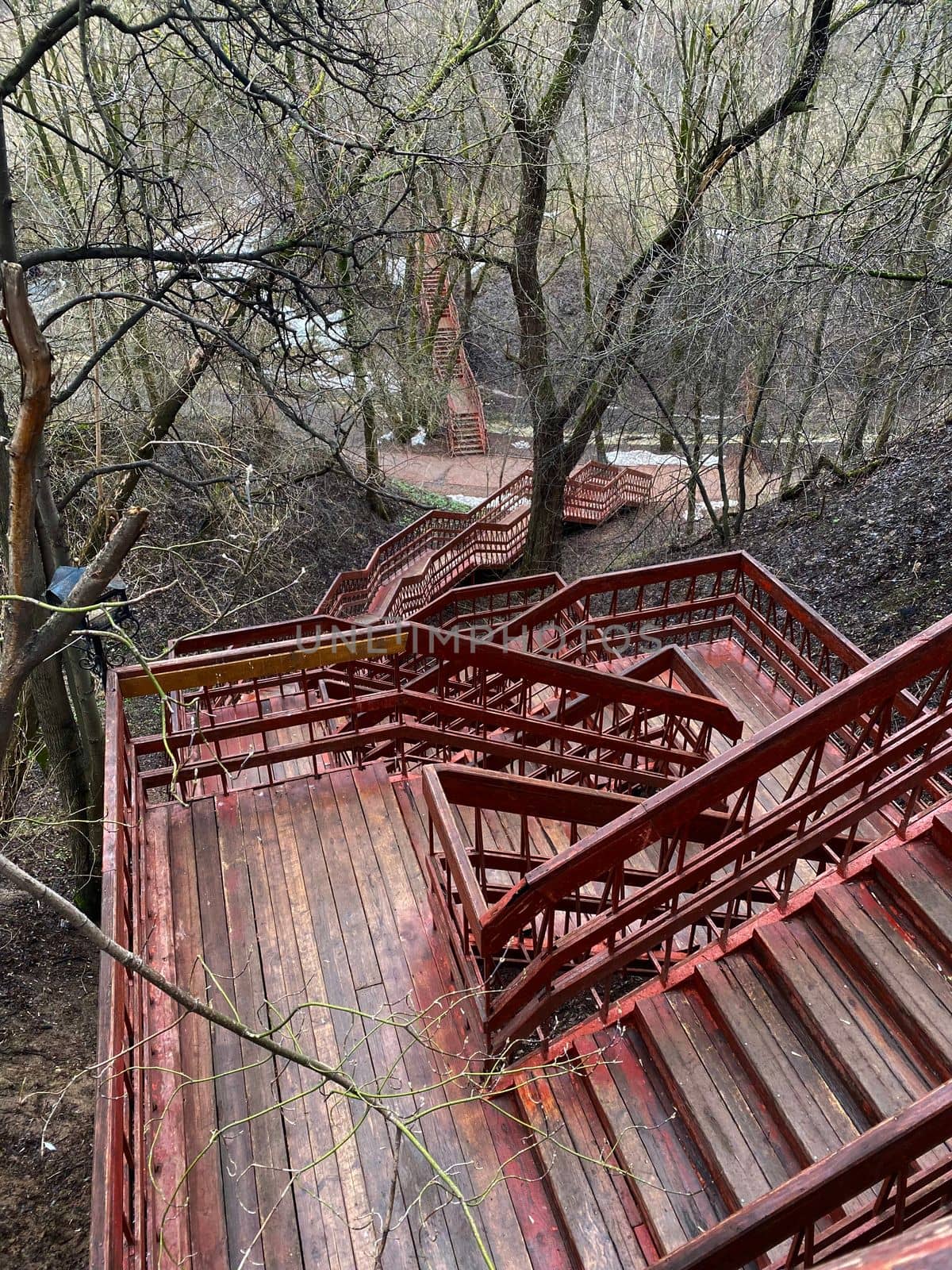 Staircase in the park. The photo shows red wooden stairs in the park.
