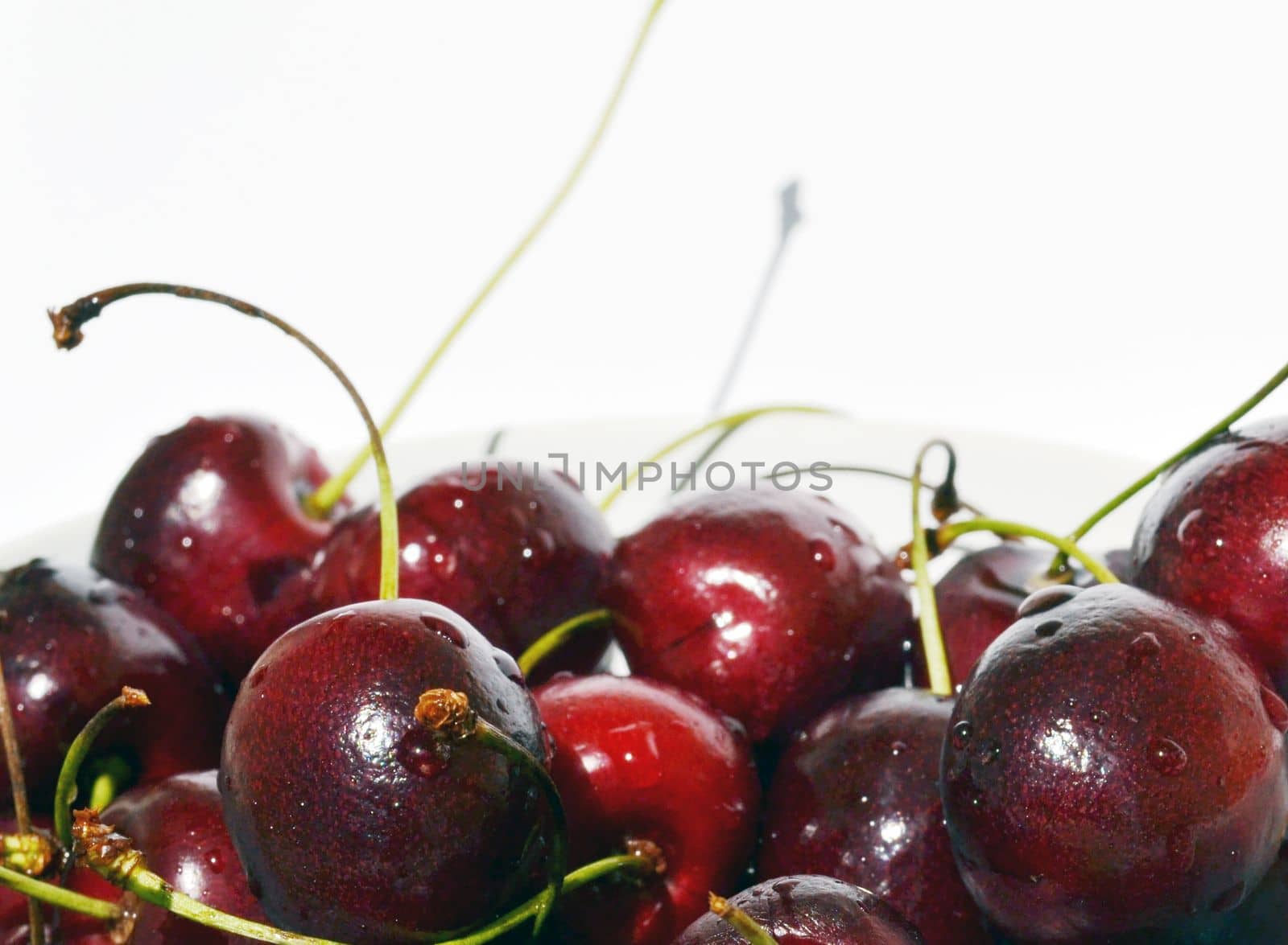 Cherry in a bowl on a white background.