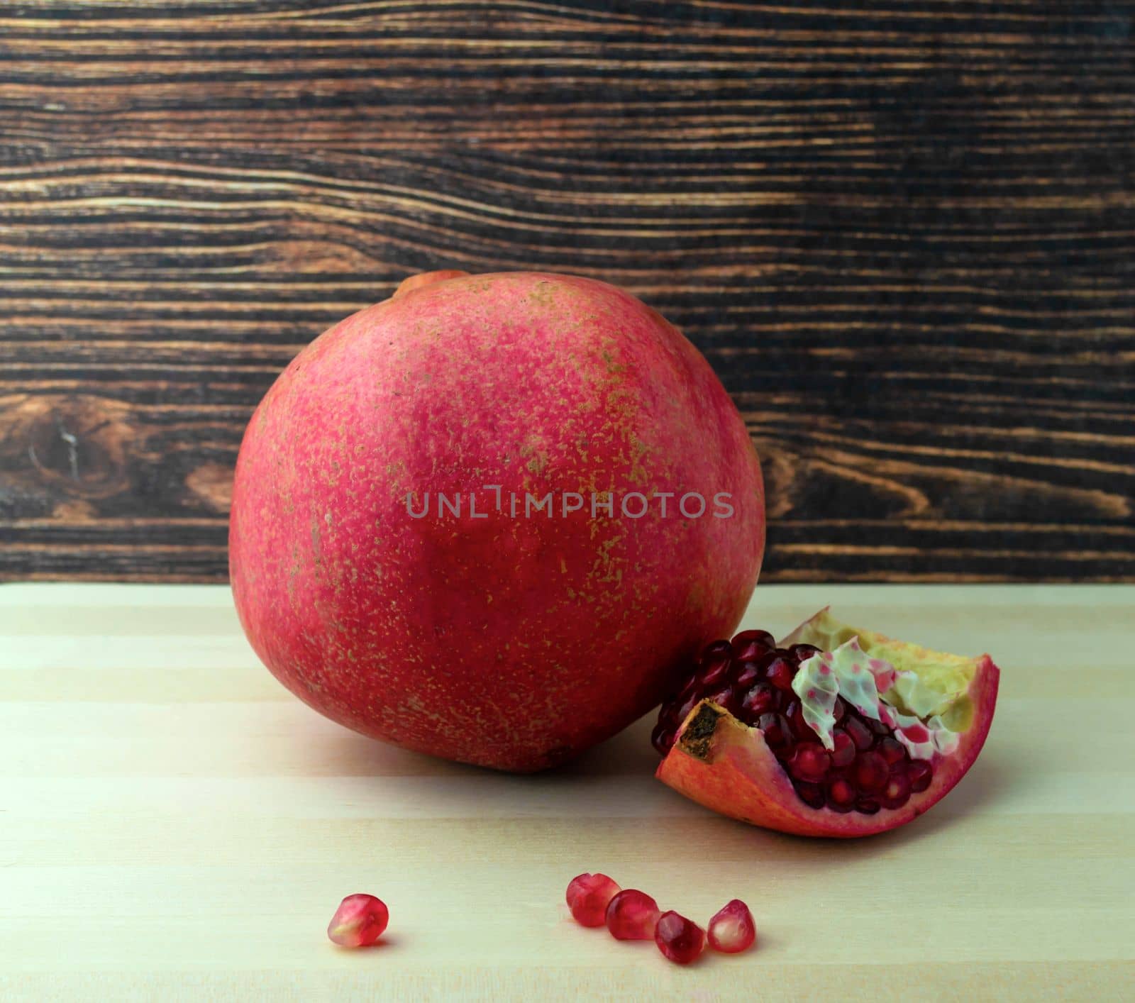 Pomegranate, photo. Photo of a pomegranate on a wooden table.