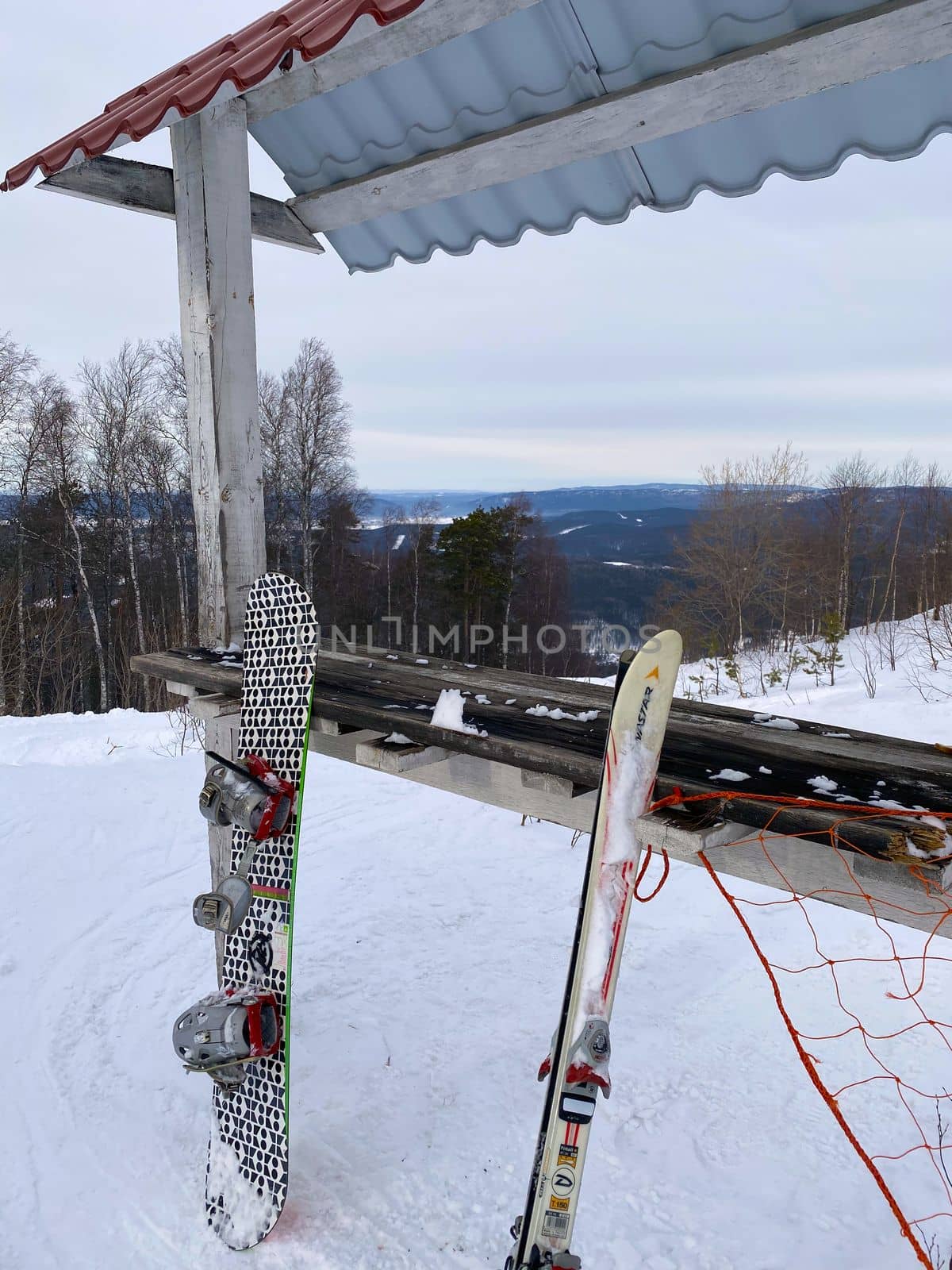 Mount Zavyalikha, Russia, February 13, 2021. The photo shows a view from the mountain, in the foreground a snowboard, skiing.
