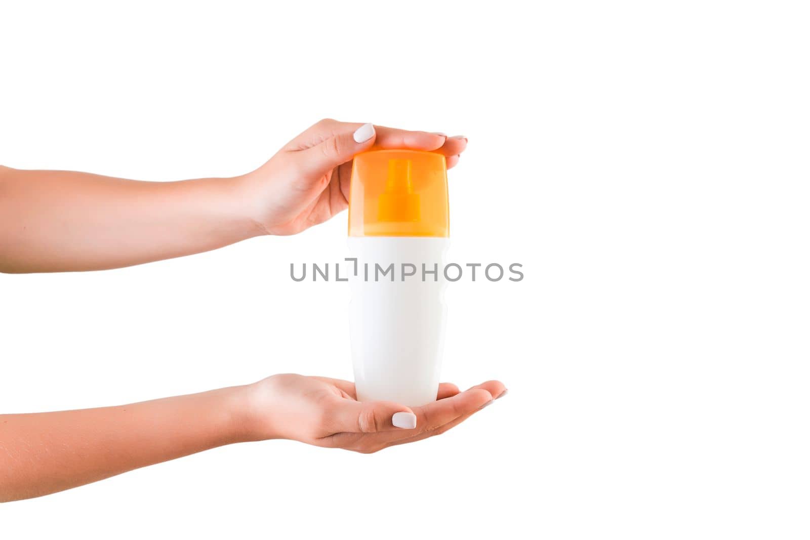 Female hand holding cream bottle of lotion isolated. Girl give cosmetic products on white background.