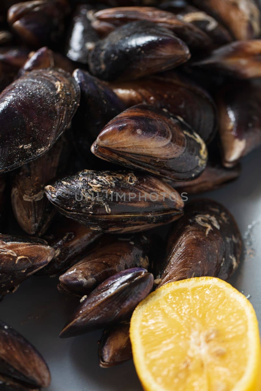 Close up of a plate with freshly coocked mussels on dining table by senkaya