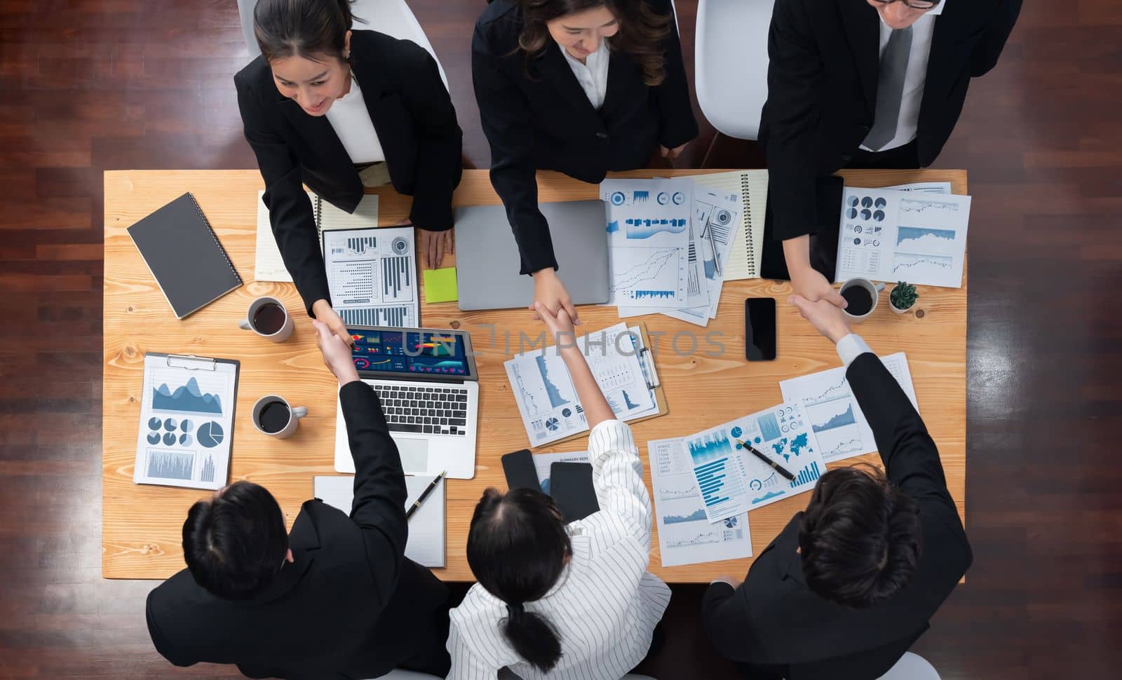 Top-view business team of financial data analysis meeting with business intelligence, report paper and dashboard on laptop for marketing strategy. Business people working together in office of harmony