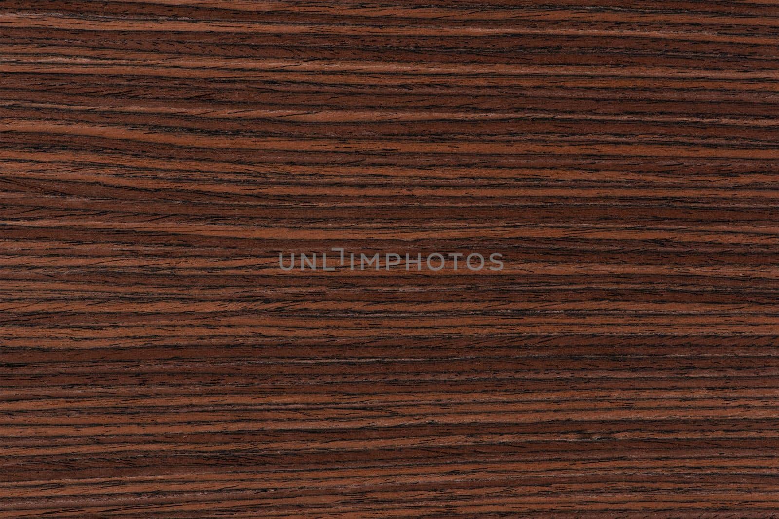 Rosewood texture. Texture of dark mahogany with an intense pattern, natural rosewood veneer for the production of furniture or yacht decoration.