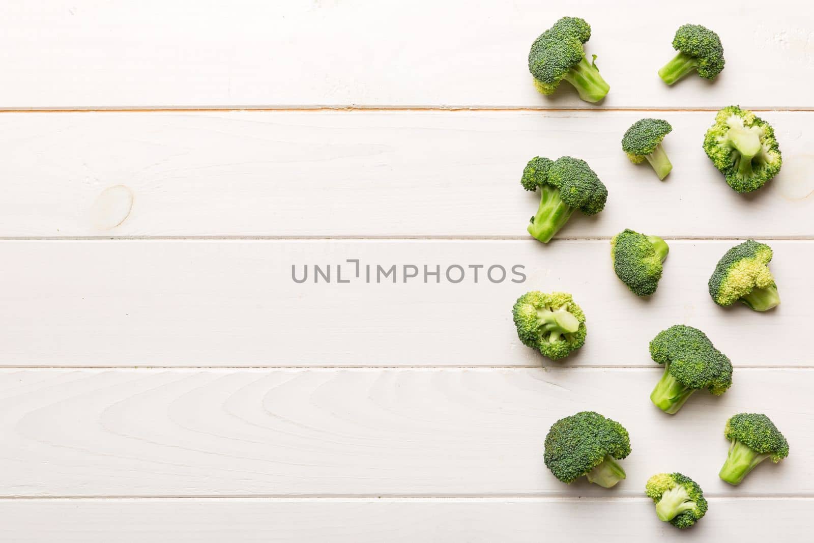 Broccoli scattered on white wooden table.copy space.Top view