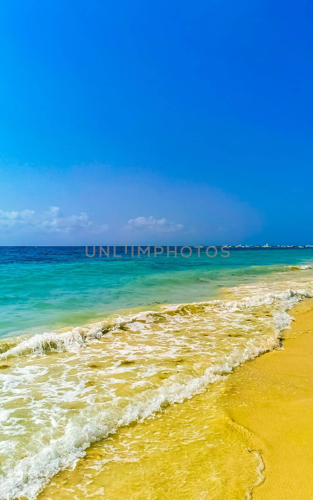 Tropical caribbean beach landscape panorama with clear turquoise blue water in Playa del Carmen Mexico.