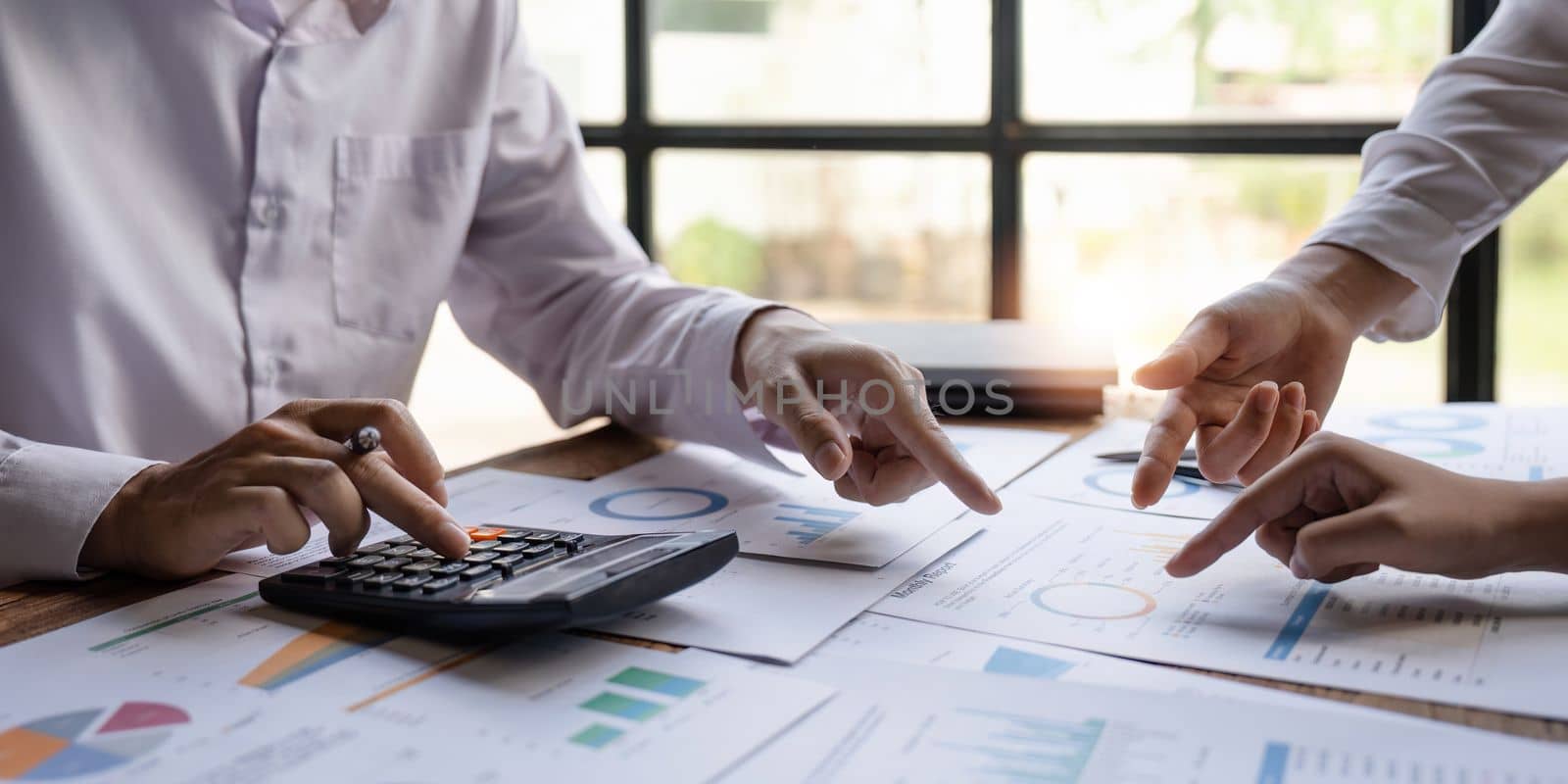 Economic business discussions, Business team analyzing income charts and graphs to plan marketing concept with using computer laptop and calculator for analysis.