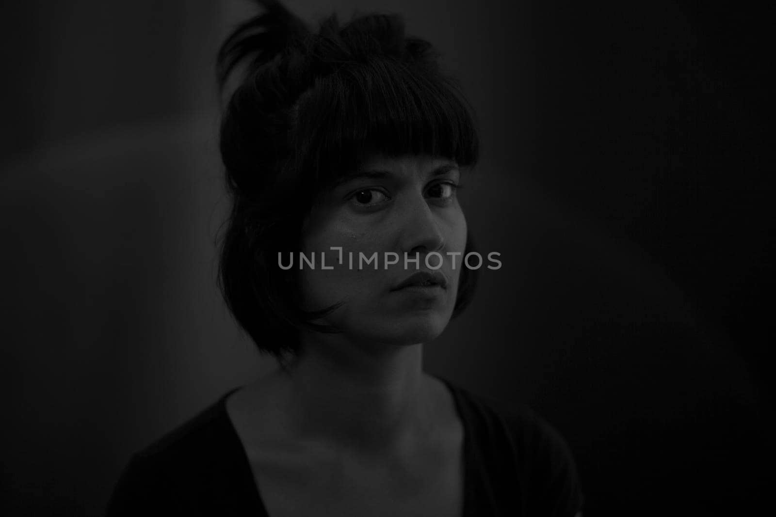 Dramatic portrait of an indian girl on black background