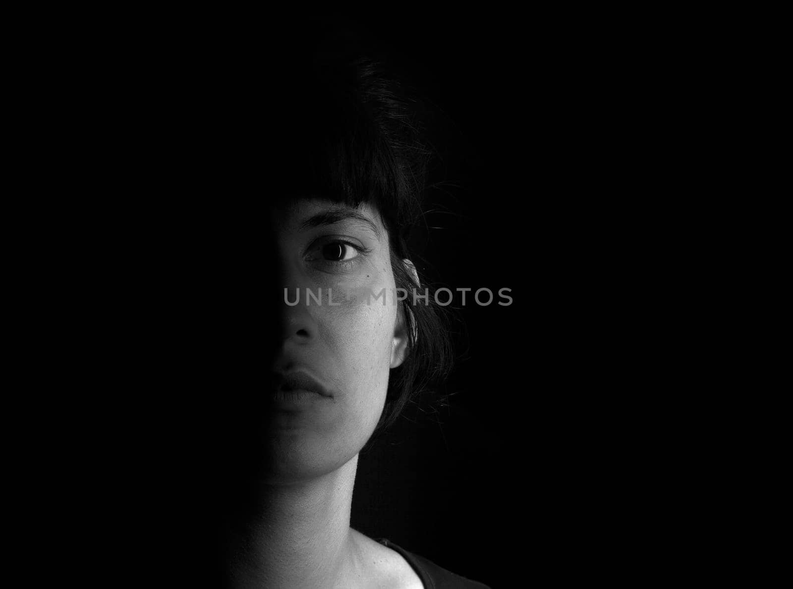 Dramatic portrait of an indian girl on black background