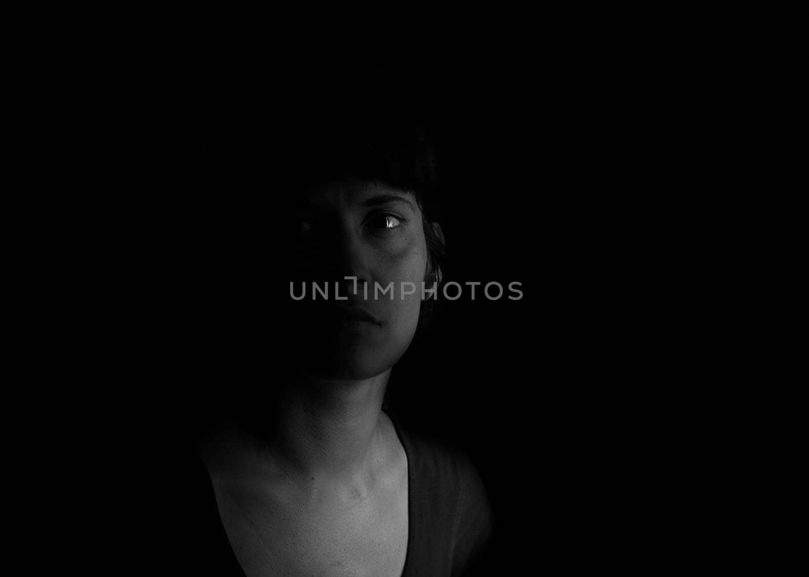 Dramatic portrait of an indian girl on black background