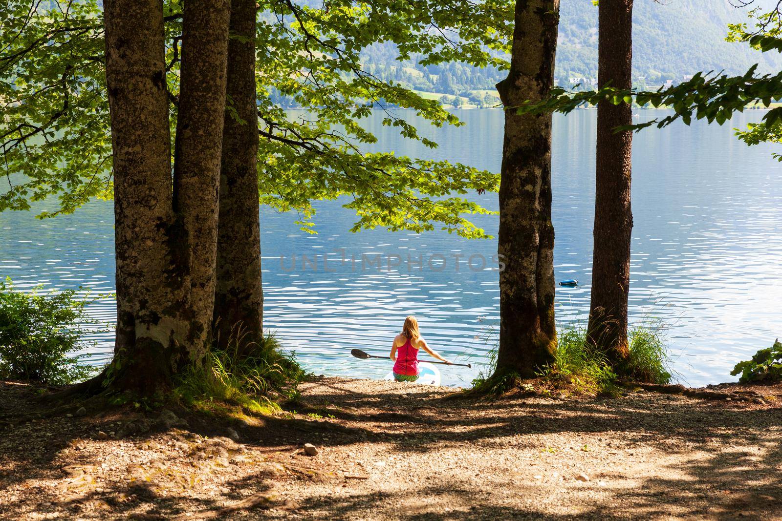 Girl kayaking in the scenic Bohinj lake, Slovenia