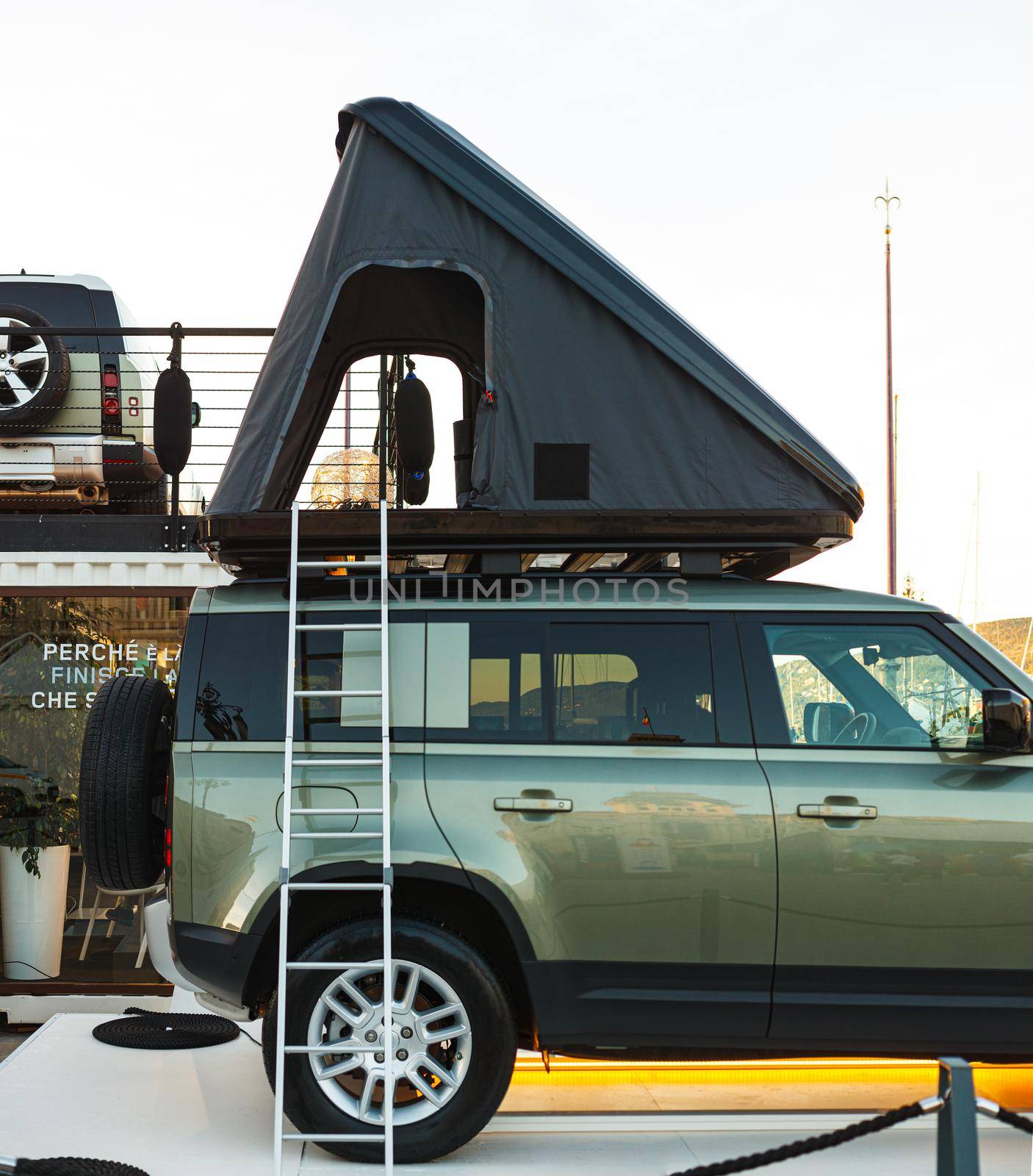 Roof top tent on a metallic green 4x4 car
