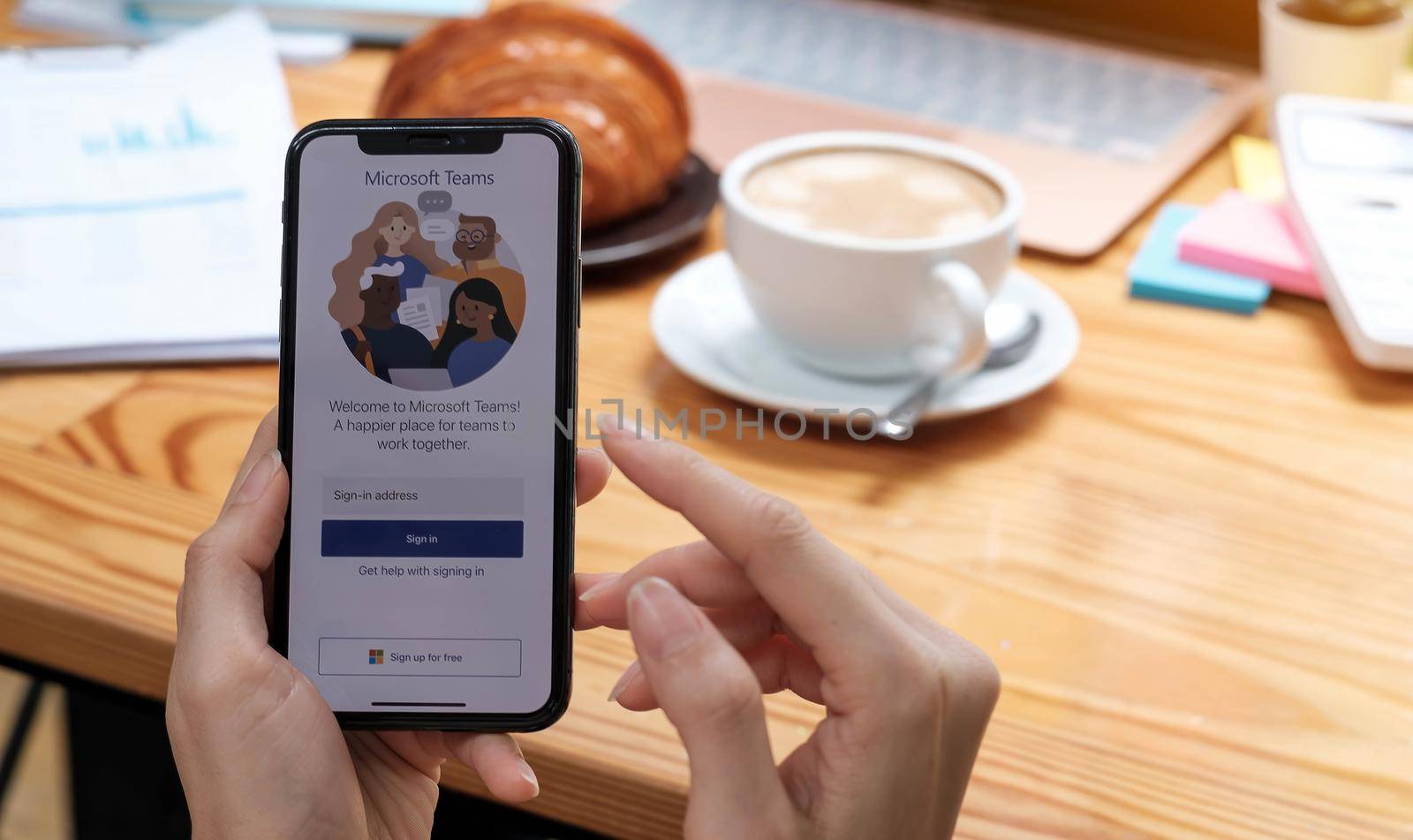 CHIANG MAI, THAILAND - APR 11, 2020 : A working from home employee is downloading the Microsoft Teams social platform, ready for remote working in isolation from home by wichayada