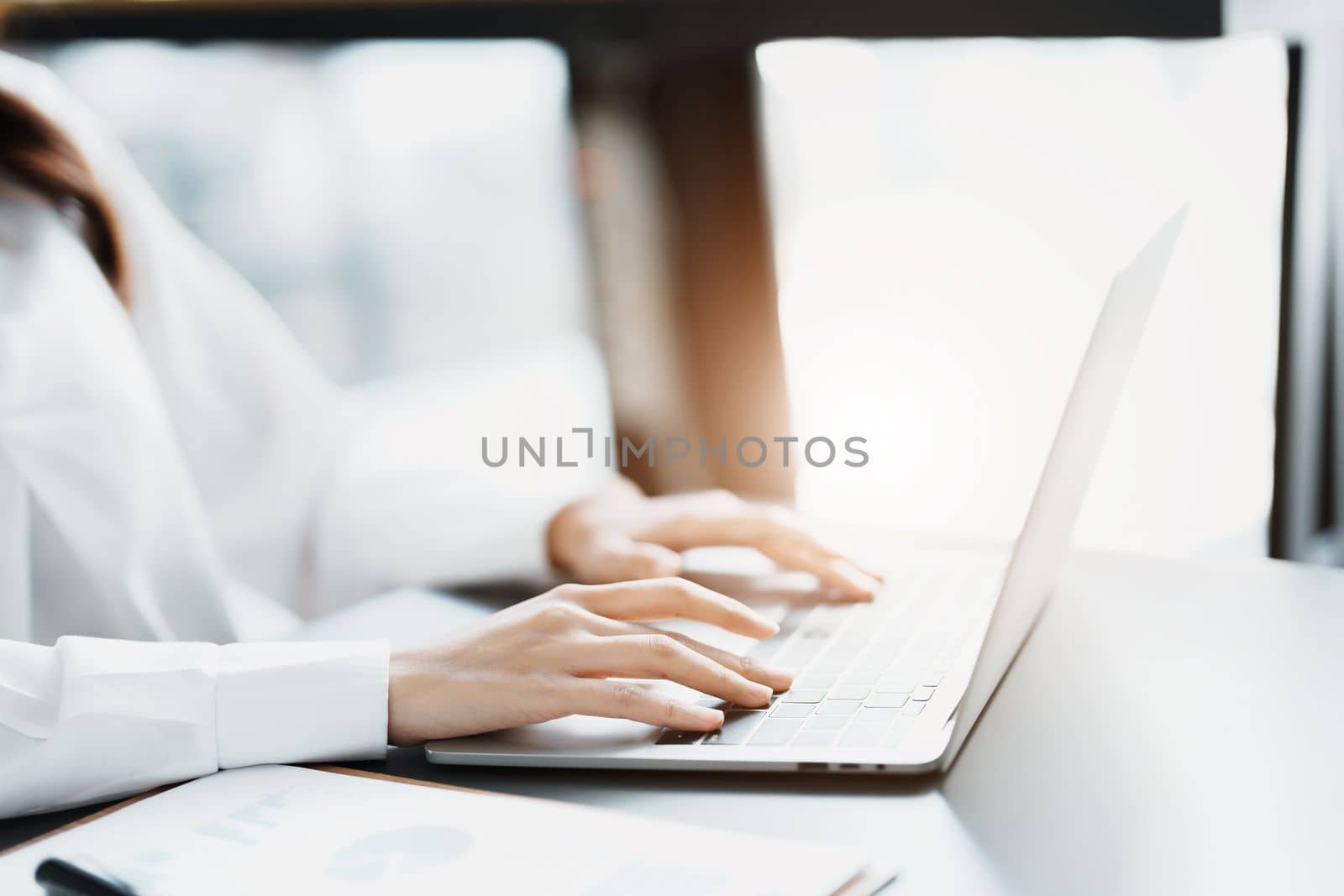 Portrait of a business woman working on a computer at work by Manastrong