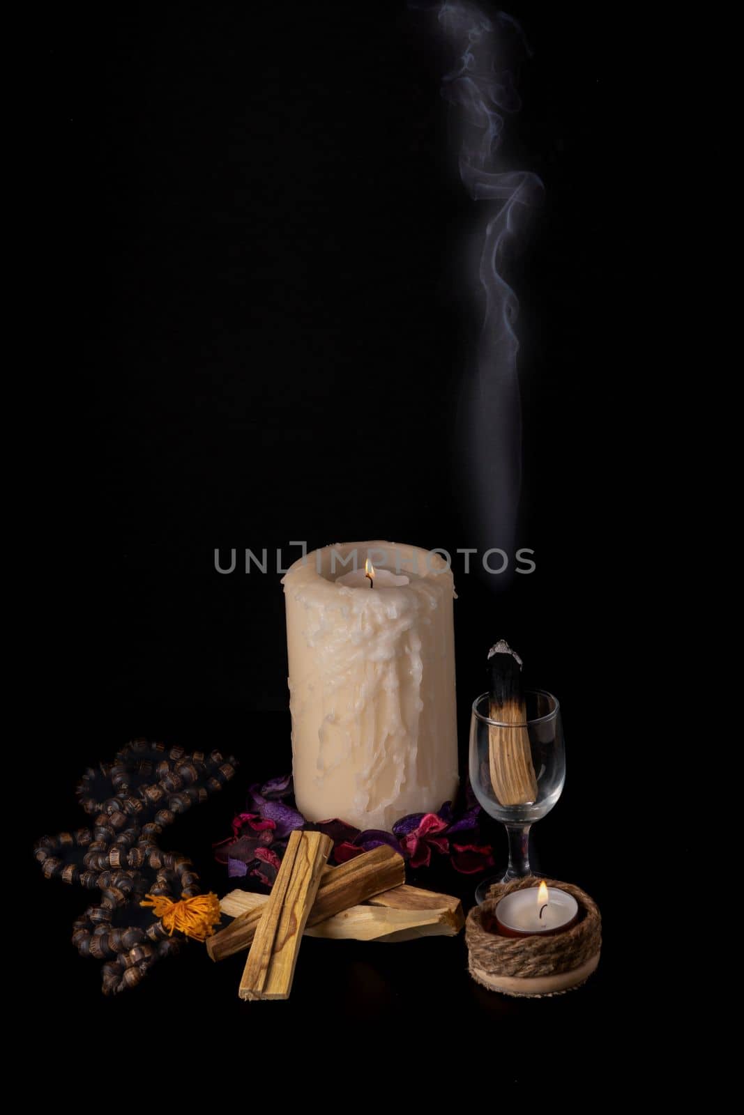 palo santo ,holy stick smoking in a glass cup by joseantona